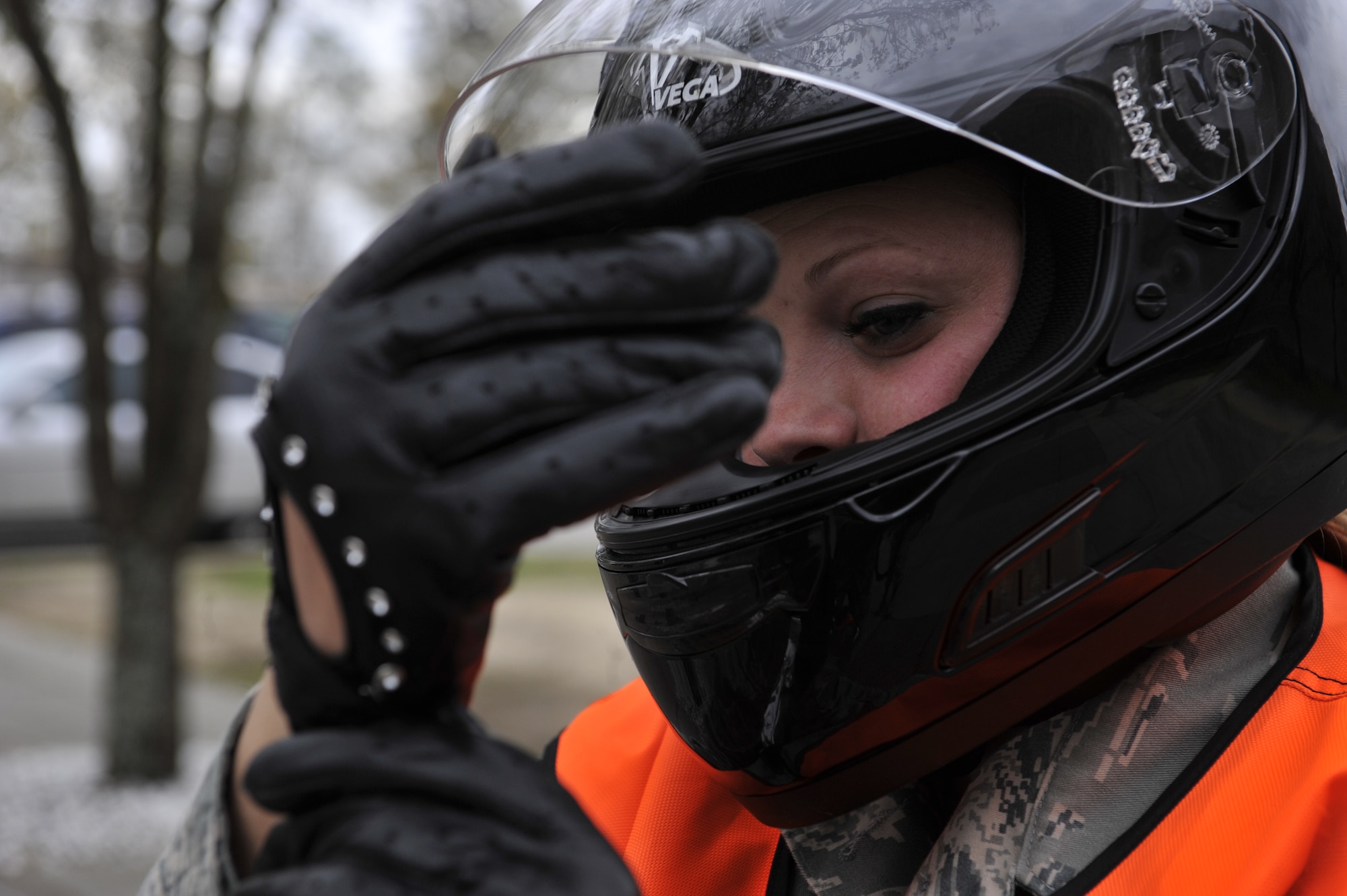 SHAW AIR FORCE BASE, S.C. - U.S. Air Force Staff Sgt. Cassandra Jenniges, a native of Lamberton, Minn., and currently assigned to the 20th Force Support Squadron, secures her riding gloves , which is an essential item of her protective equipment needed before riding her motorcycle on March 9, 2012.  (U.S.  Air Force photo/Master Sgt. Cohen A. Young/Released)
