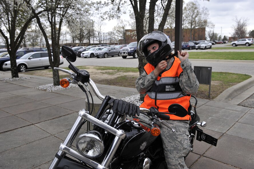 SHAW AIR FORCE BASE, S.C. - U.S. Air Force Staff Sgt. Cassandra Jenniges, a native of Lamberton, Minn., and currently assigned to the 20th Force Support Squadron, tightens her chin strap after donning her helmet before riding her motorcycle on March 9, 2012. (U.S.  Air Force photo/Master Sgt. Cohen A. Young/Released)