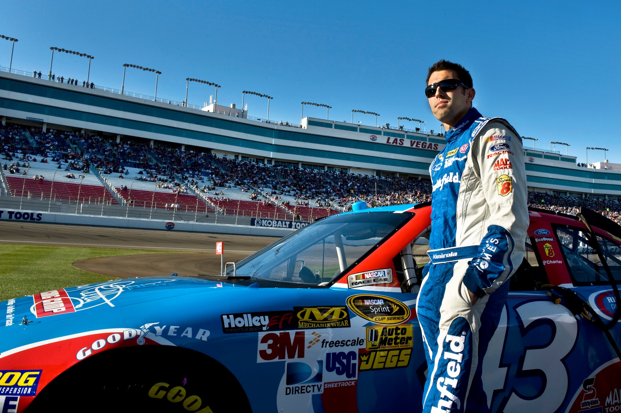 Aric Almirola, driver for the Air Force-sponsored No. 43 car, stands near his ride prior to the qualifying round for the Sprint Cup Series Race March 9, 2012 at the Las Vegas Motor Speedway. Almirola said he draws inspiration from Airmen as role models. (U.S. Air Force photo by Airman 1st Class Daniel Hughes)

