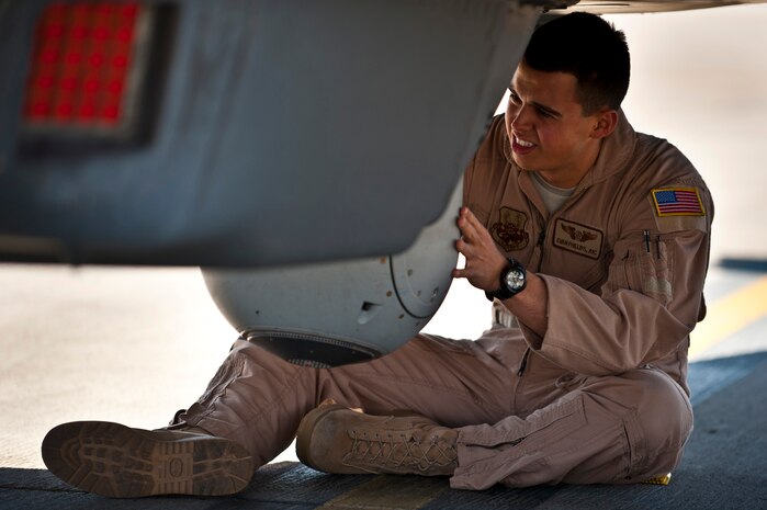 Airman 1st Class Evan Phillips, 489th Reconnaissance Squadron communications operator, inspects an MX-15 turret underneath an MC-12 Liberty during Red Flag 12-3, March 13, 2012 at Nellis Air Force Base, Nev. The MX-15 is a light-weight imaging system that provides intel during operations. (U.S. Air Force photo by Senior Airman Brett Clashman)