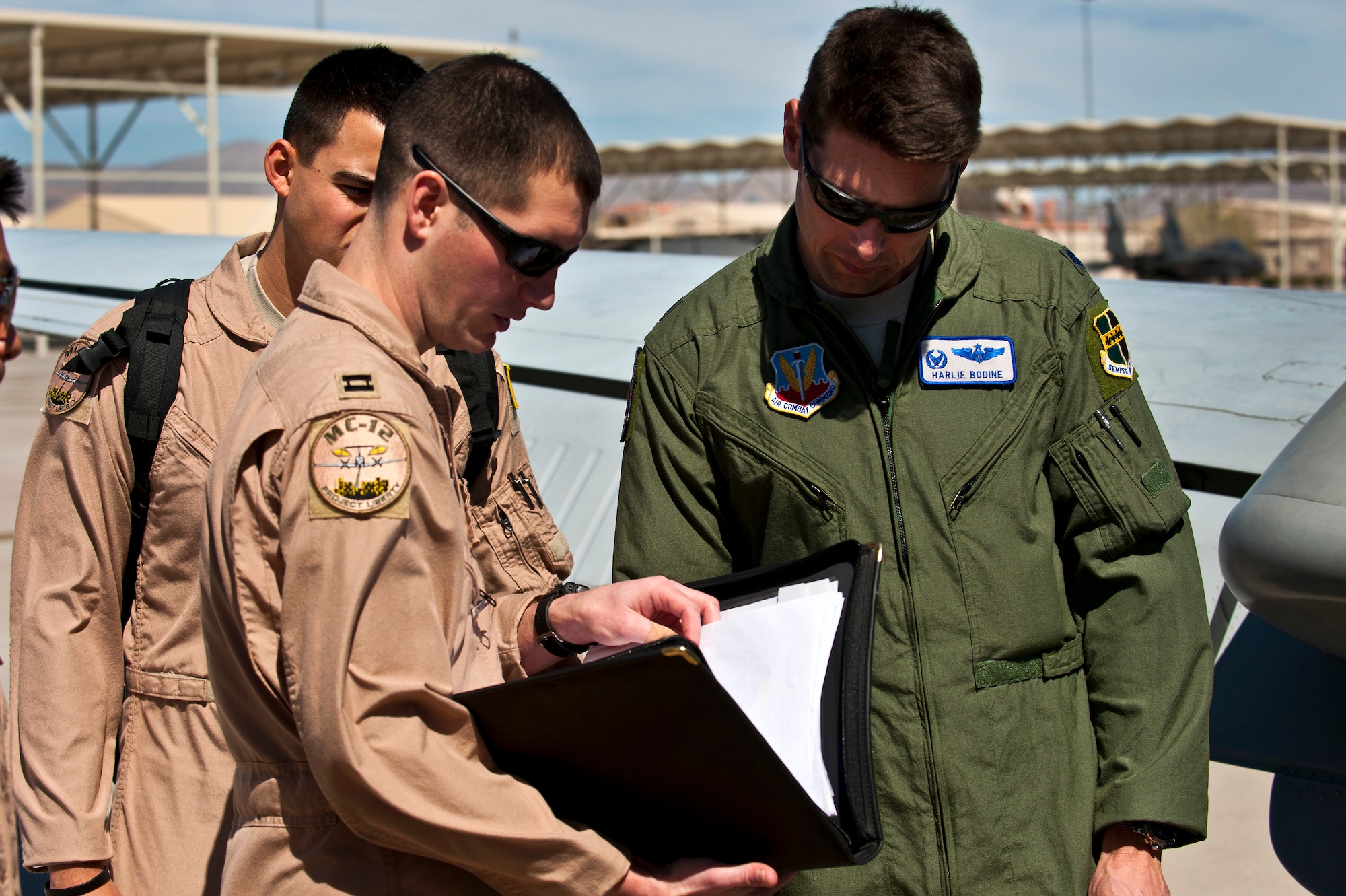 Lt. Col. Harlie Bodine, 489th Reconnaissance Squadron commander, reviews a mission log with crew members during Red Flag 12-3, March 13, 2012 at Nellis Air Force Base, Nev. Red Flag is a realistic air-to-air combat training exercise involving the air forces of the United States and its allies. (U.S. Air Force photo by Senior Airman Brett Clashman)