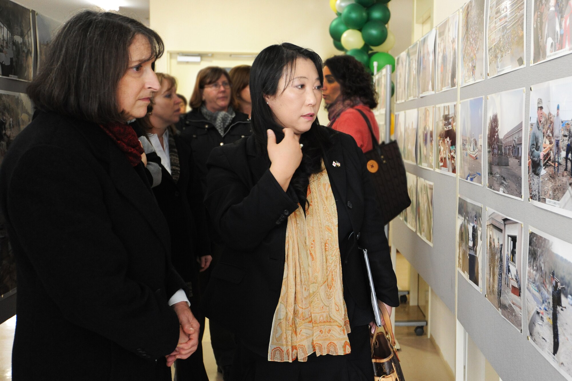 Shelley North, left, wife of U.S. Air Force Gen. Gary North, Pacific Air Forces commander, and Kyoko Hasegawa, 35th Fighter Wing Public Affairs chief of community relations, review images from Operation Tomodachi at Sky Plaza, Misawa City, Japan, March 6, 2012. The photo exhibit featuring disaster relief efforts during Operation Tomodachi is on display until March 18 in remembrance of the earthquake and subsequent tsunami on March 11, 2011. (U.S. Air Force photo by Airman 1st Class Kia Atkins/Released)