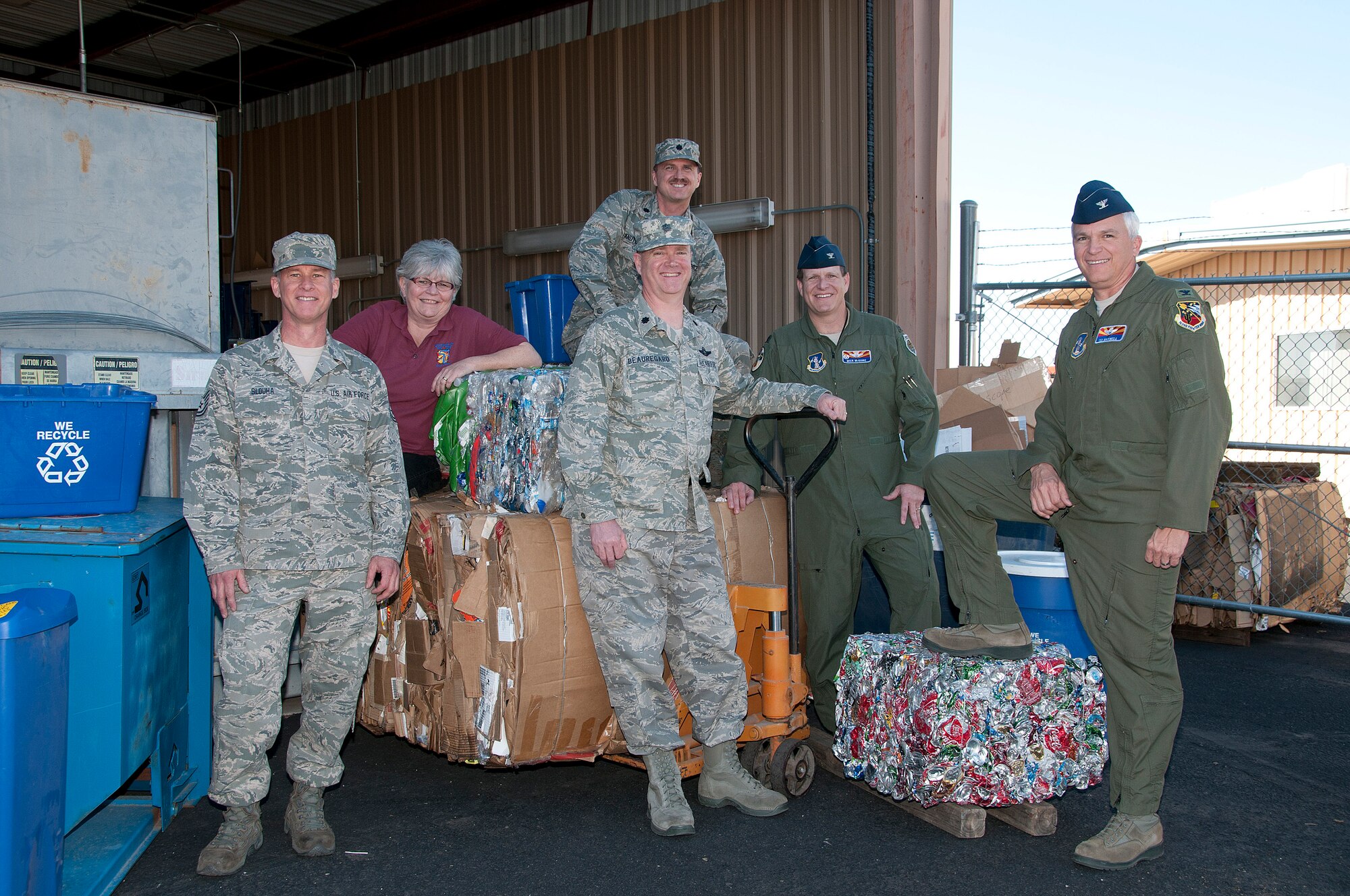 (From the left) Tech. Sgt. Rick Slouha, Cheryl Settle, Lt. Col. Mike Knutson (back), Col. Garry Beauregard, Col. Mick McGuire and Col. Ted Maxwell survey the 162nd Fighter Wing's recycling area south of building 28 on base. The wing's recycling program was recently named "Best in the Air National Guard." (U.S. Air Force photo/Master Sgt. Dave Neve)