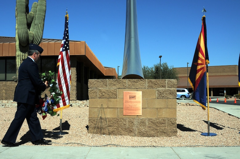 Col. Steven M. Balser, 161st Air Refueling Wing commander, lays a wreath on new memorial featuring a KC-135 Stratotanker tail and plaque, dedicated during a memorial ceremony March 13, 2012, at the 161st Air Refueling Wing, Phoenix. The memorial ceremony marked the 30th anniversary when four 161st Air Refueling Group servicemembers lost their lives while on-duty. (Photo by Staff Sgt. Michael Matkin/Released)