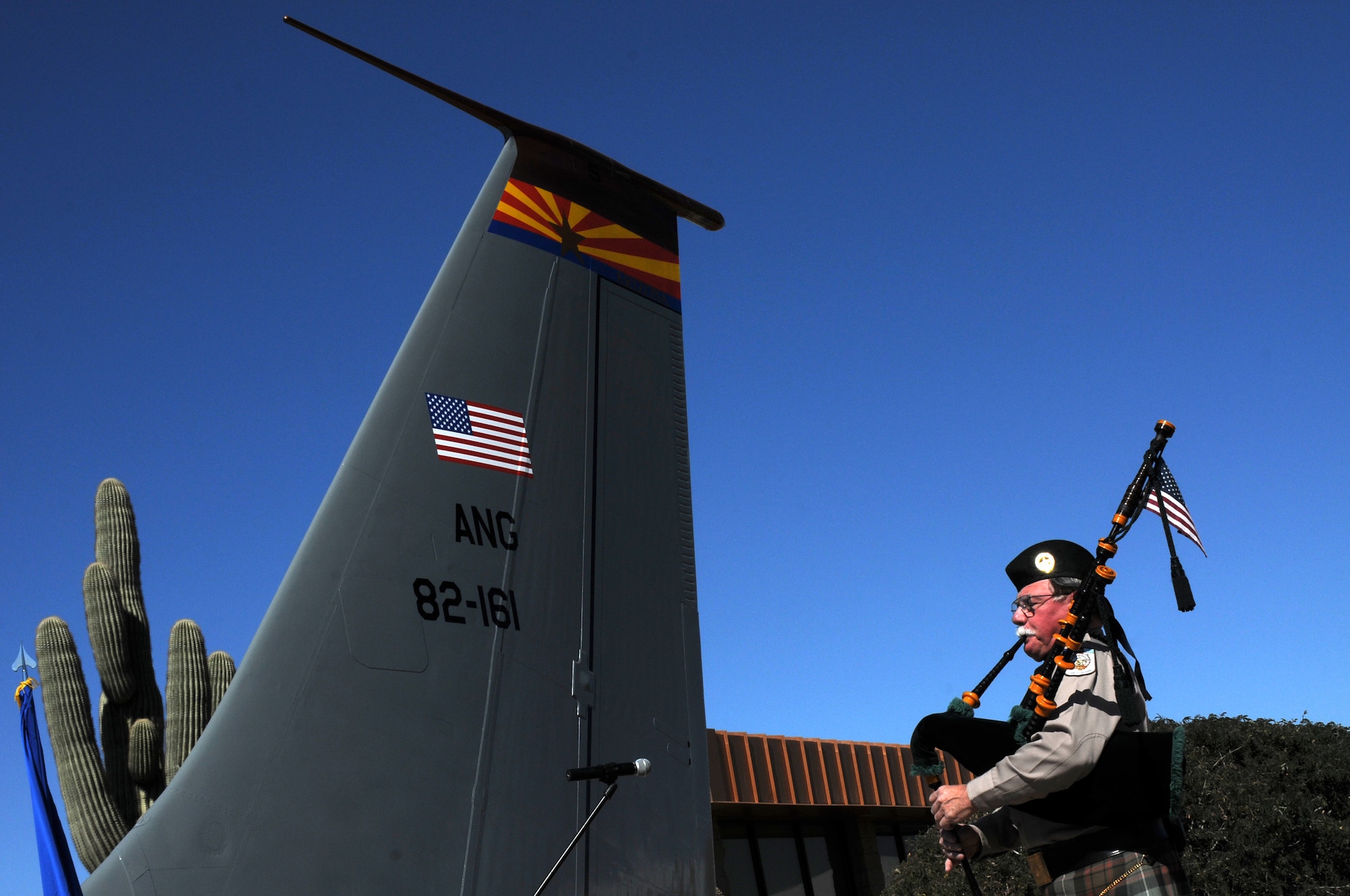 Mr. Eric Landau plays the national anthem during a memorial ceremony dedicating a KC-135 Stratotanker tail and plaque March 13, 2012, at the 161st Air Refueling Wing, Phoenix. The memorial ceremony marked the 30th anniversary when four 161st Air Refueling Group servicemembers lost their lives while on-duty. (Photo by Staff Sgt. Michael Matkin/Released)