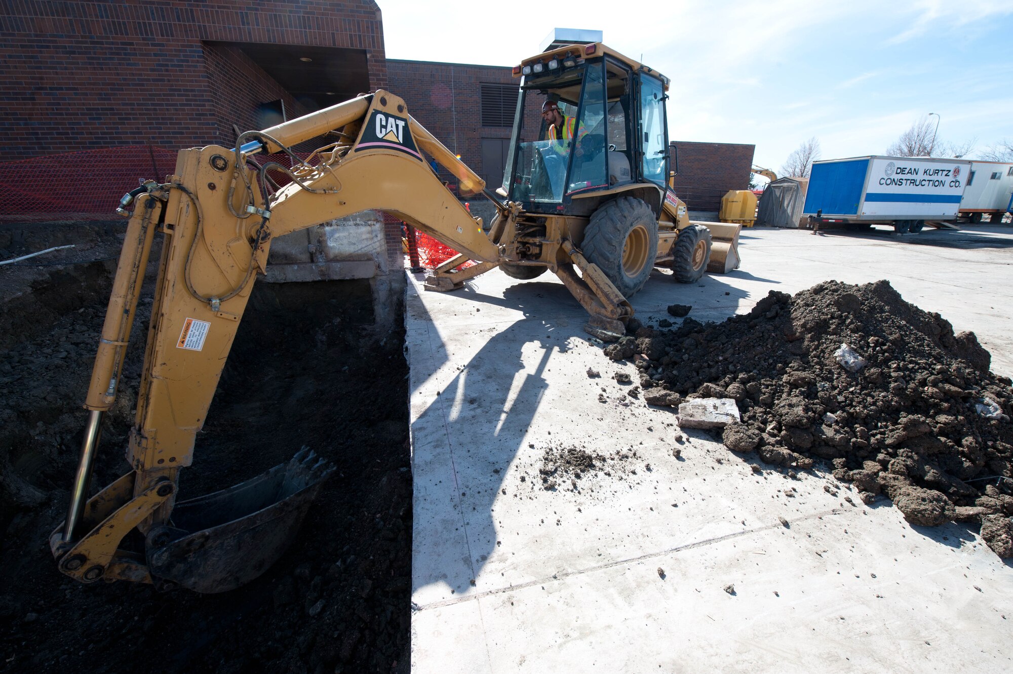 Justin Smith, civilian contractor from Iron Horse Excavating Company, clears dirt and cement during renovation at Ellsworth Air Force Base, S.D., March 9, 2012. The Bandit Inn dining facilities construction project is part of a 4.5 million dollar life cycle renovation to improve and upgrade the facility that was built over 20 years ago. (U.S. Air Force photo by Airman 1st Class Zachary Hada/Released)