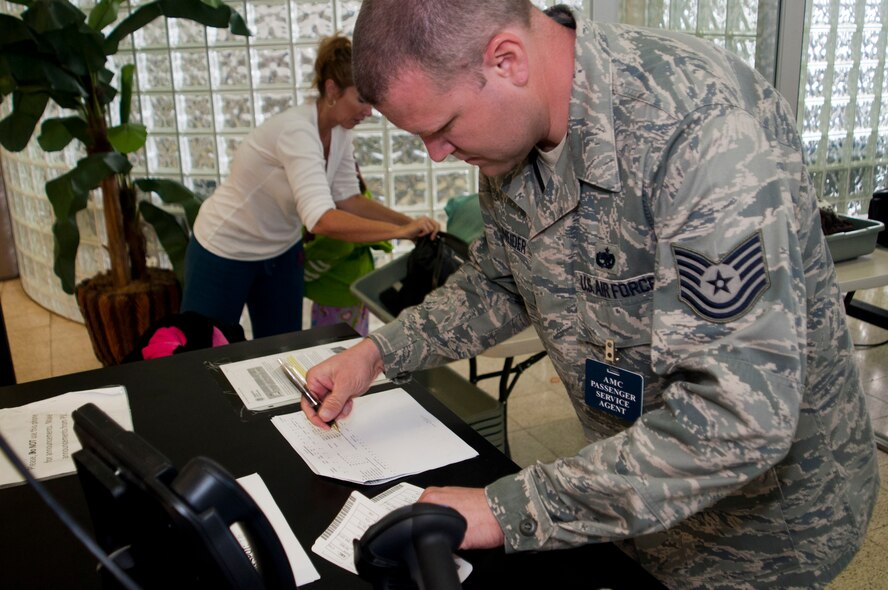 Tech. Sgt. William Schneider, 67th Aerial Port Squadron training supervisor, checks tickets against the passenger manifest at the gate for flights departing from Hickam’s air passenger terminal. (U.S. Air Force Photo/Staff Sgt. Kyle Brasier)