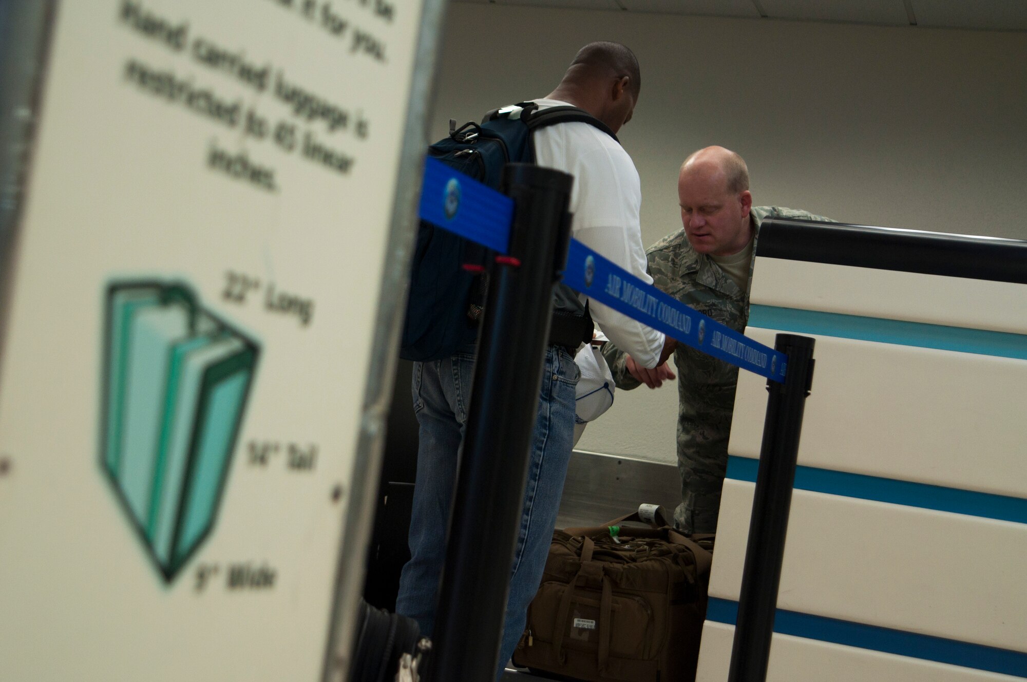 Staff Sgt. Kent Brailsford, 67th Aerial Port Squadron air transportation specialist, helps a customer at Hickam’s air passenger terminal. A group of Airmen from the 67th APS is completing the 15-day annual tour requirements here working alongside active duty personnel at the terminal. (U.S. Air Force Photo/Staff Sgt. Kyle Brasier)