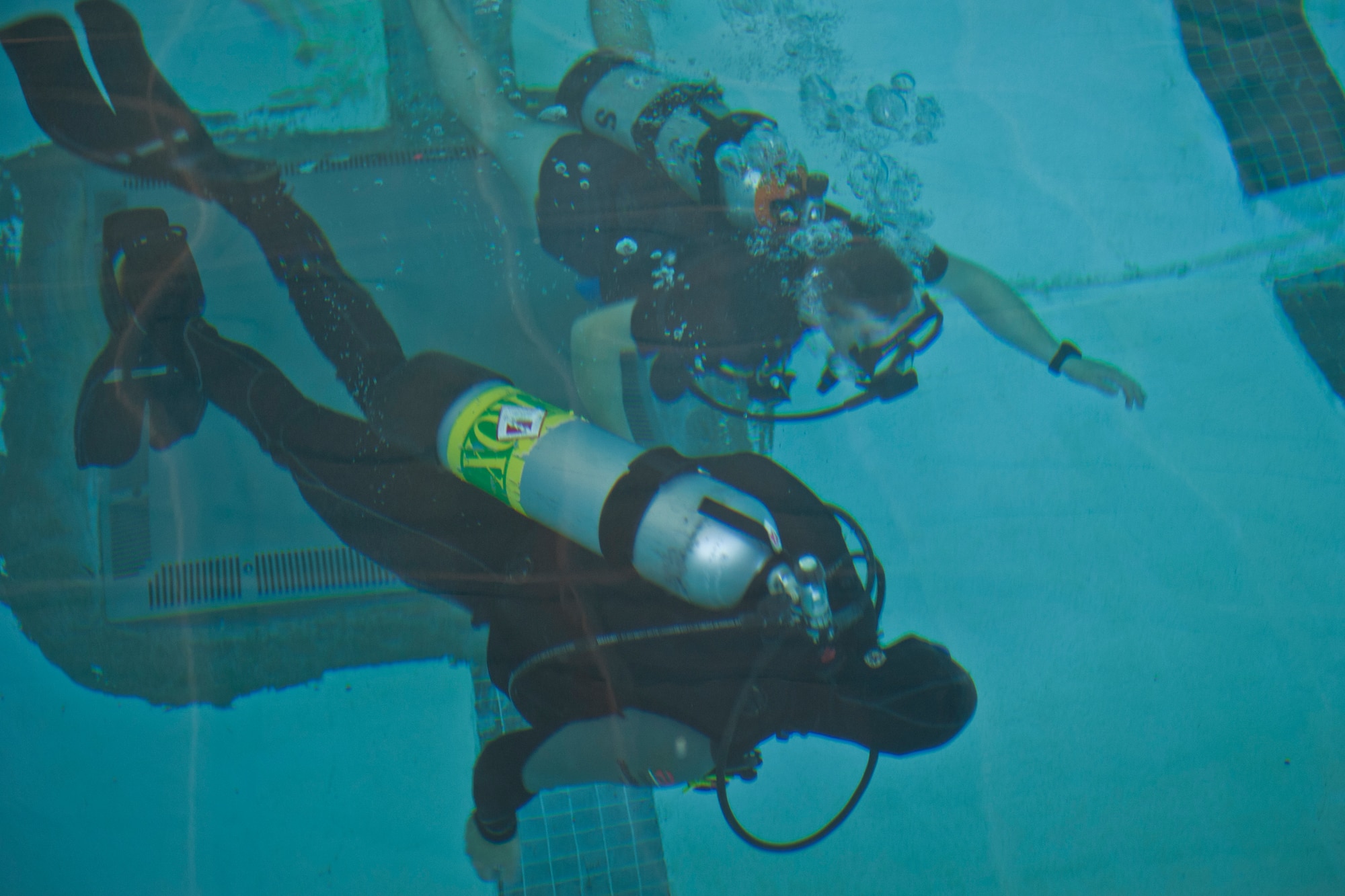 U.S. Air Force Senior Airman Erik Smith, 820th Combat Operations Squadron K-9 unit, swims with an instructor during a discover scuba course at Moody Air Force Base, Ga., March 10, 2012. Airmen had the chance to wear scuba gear and test it out to see if they would be interested in taking part in actual scuba certification course.(U.S. Air Force photo by Airman 1st Class Nicholas Benroth/Released)