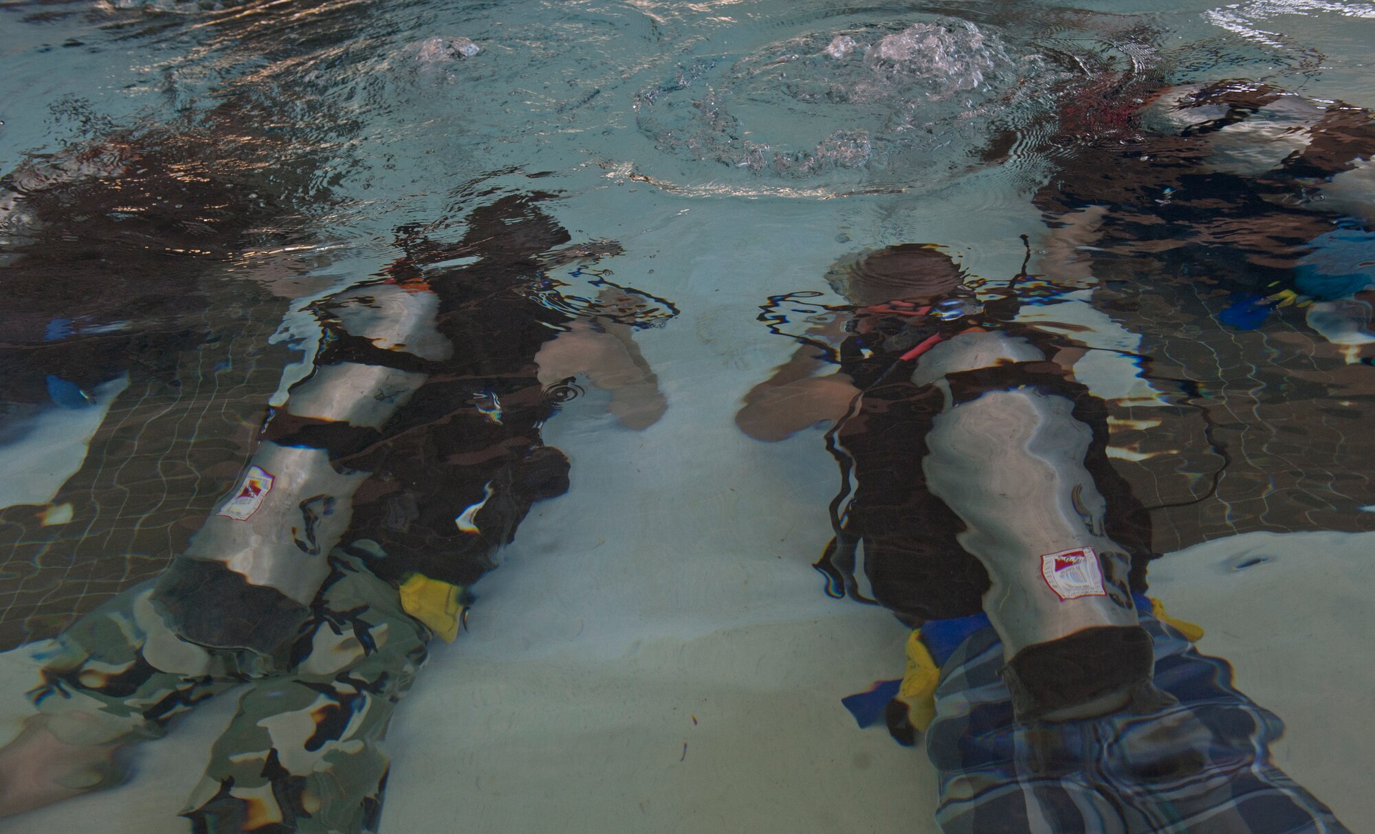Team Moody Airmen use scuba gear at the indoor pool as part of the discover scuba course at Moody Air Force Base, Ga., March 10, 2012. Each Airmen spent approximately an hour in the water. They, first, learned about the equipment then applied their new knowledge as they swam. (U.S. Air Force photo by Airman 1st Class Nicholas Benroth/Released)