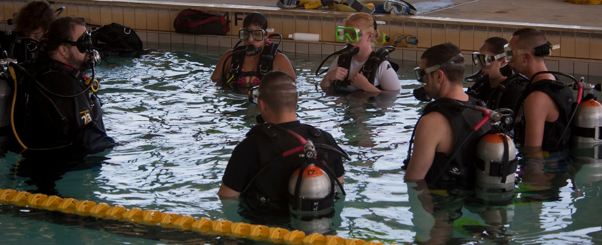Dave Stone, head instructor for the discover scuba course prepares Team Moody Airmen to use their scuba gear underwater at Moody Air Force Base, Ga., March 10, 2012. The scuba class was part of the Single Airmen Initiative, which gave Airmen the chance to try scuba for free to see if they have an interest in it. (U.S. Air Force photo by Airman 1st Class Nicholas Benroth/Released)