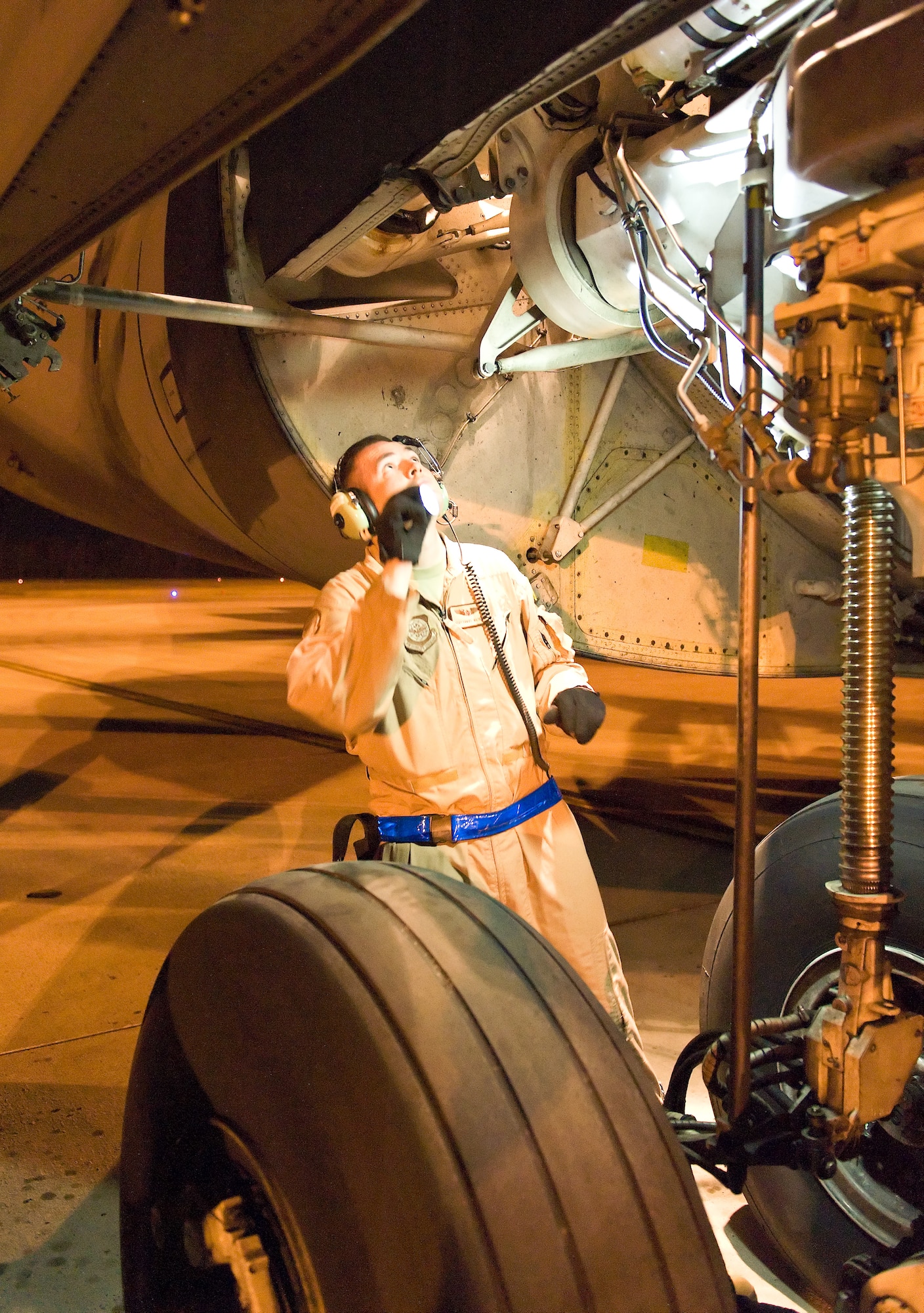 Staff Sgt. Daniel Wiltbank, a flight engineer with the 9th Airlift Squadron, inspects the main landing gear on a C-5B Galaxy during preflight March 8, 2012, at Dover Air Force Base, Del. The 9th Airlift Squadron now exclusively employs the C-5M Super Galaxy for local training, and state-side and overseas missions. (U.S. Air Force photo by Roland Balik)