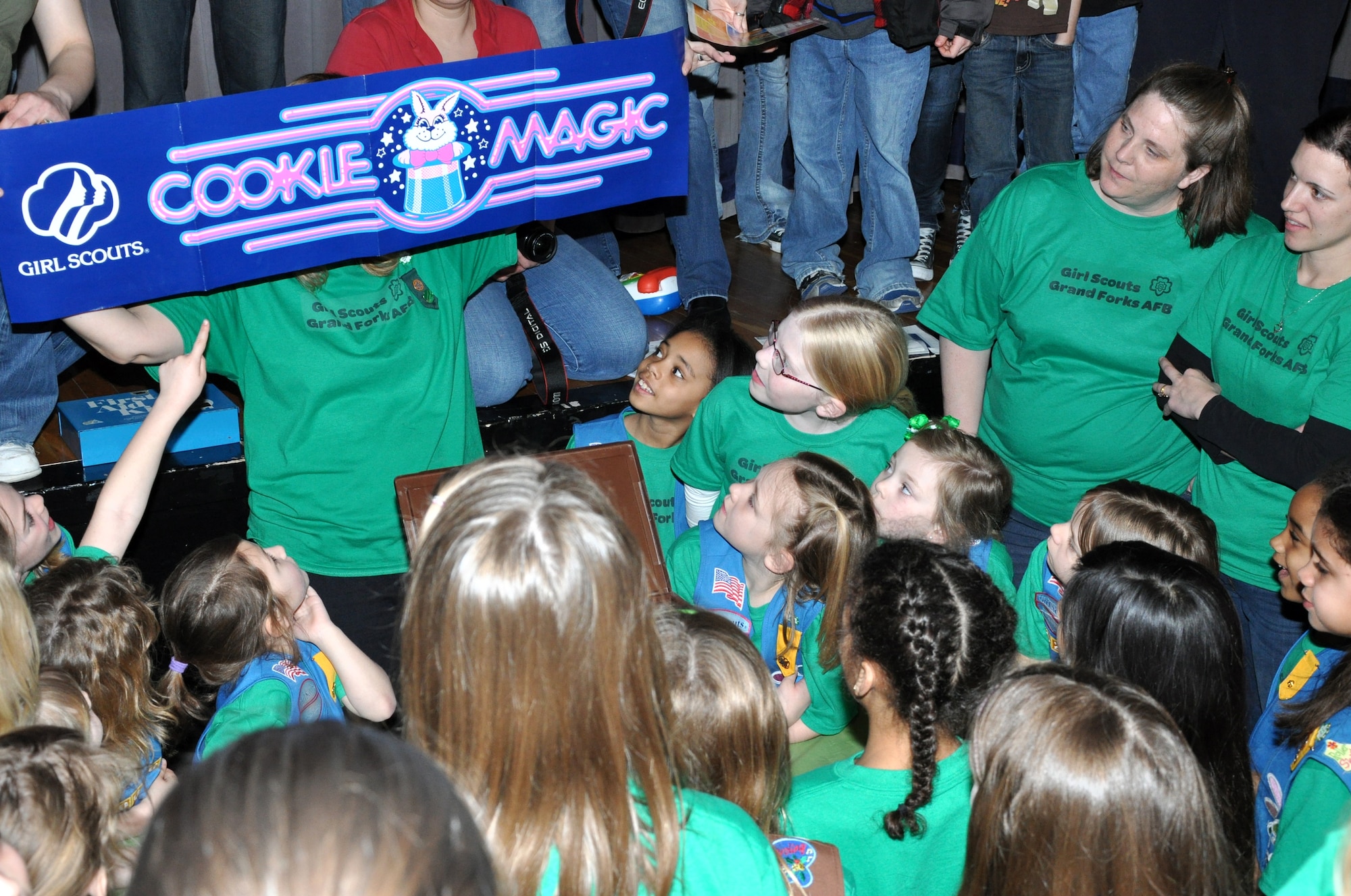 Debbie Murphy, service unit manager for the Girl Scouts from Grand Forks Air Force Base, N.D., holds up a Girl Scout cookie banner during a March 12, 2012, ceremony on base. The banner was found inside a time capsule from 1987 that was opened in celebration of the 100th anniversary of the Girl Scouts of the United States of America organization. (U.S. Air Force photo/Airman 1st Class Derek VanHorn)