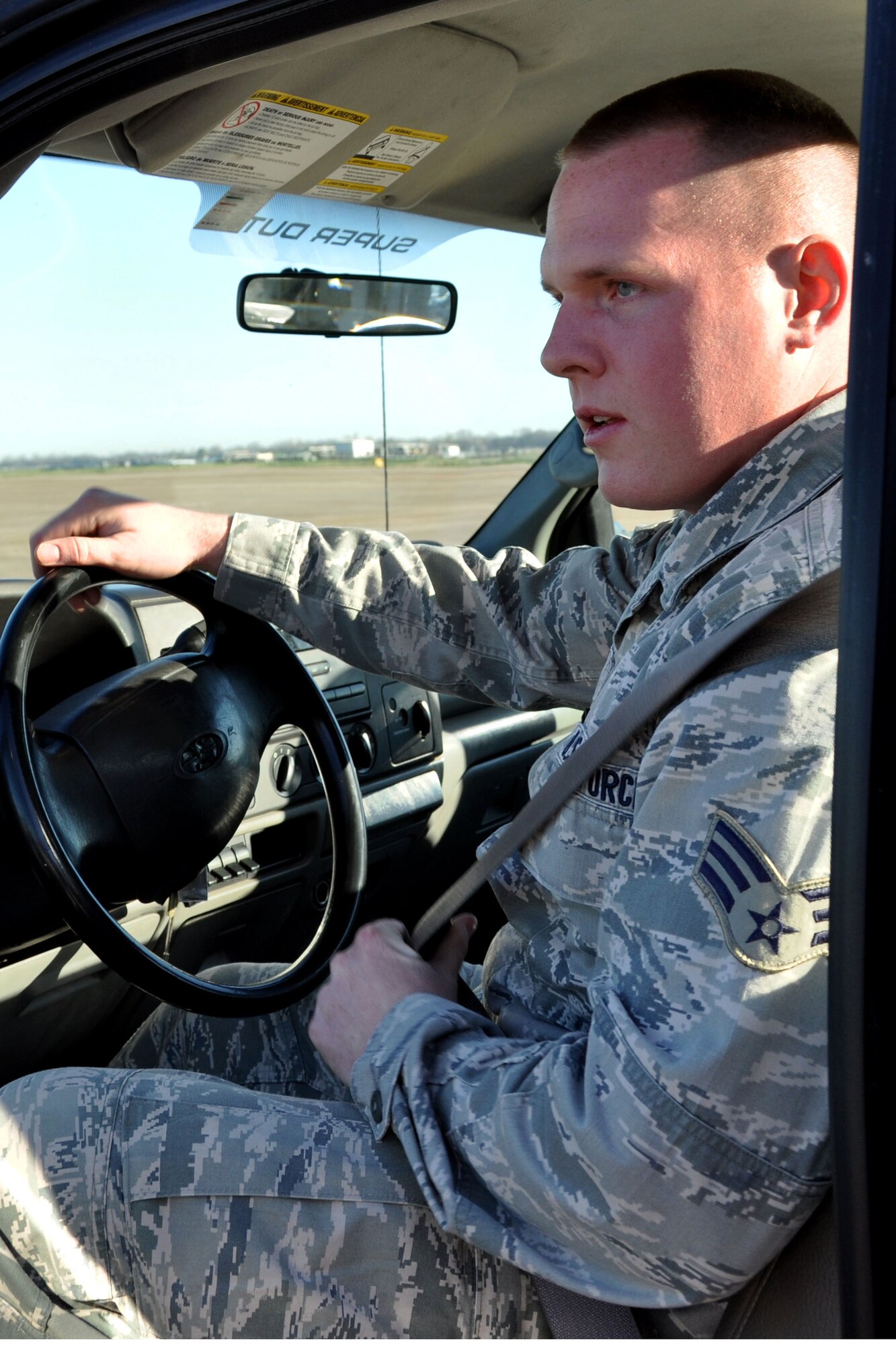U.S. Air Force Senior Airman Chad Miller, an aerospace ground equipment mechanic assigned to the 307th Maintenance Squadron, buckles his seat belt in preparation for a trip to the flight line at Barksdale Air Force Base, La., March 4, 2012.  Miller’s efforts on the flight line and overall devotion to duty earned him 307th Bomb Wing Airman of the Year honors for 2011.  (U.S. Air Force photo by Staff Sgt. Theodore Daigle/Released)