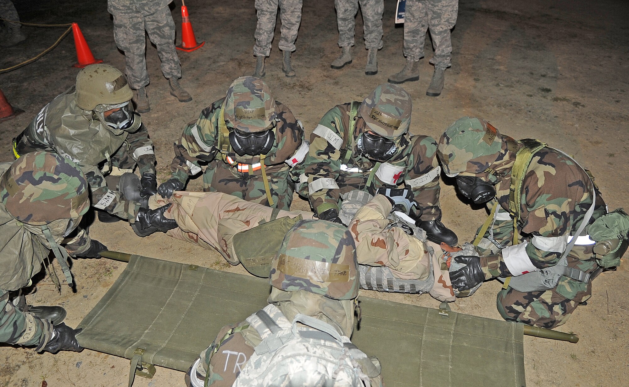 Airmen from the 4th Medical Group secure a simulated injured Airman on a stretcher during the Phase II Operational Readiness Exercise on Seymour Johnson Air Force Base, N.C., March 8, 2012. In a combat zone all injured personnel are sent to casualty collection point where medical personnel determine what care is needed. (U.S. Air Force photo/Senior Airman Gino Reyes/Released)
