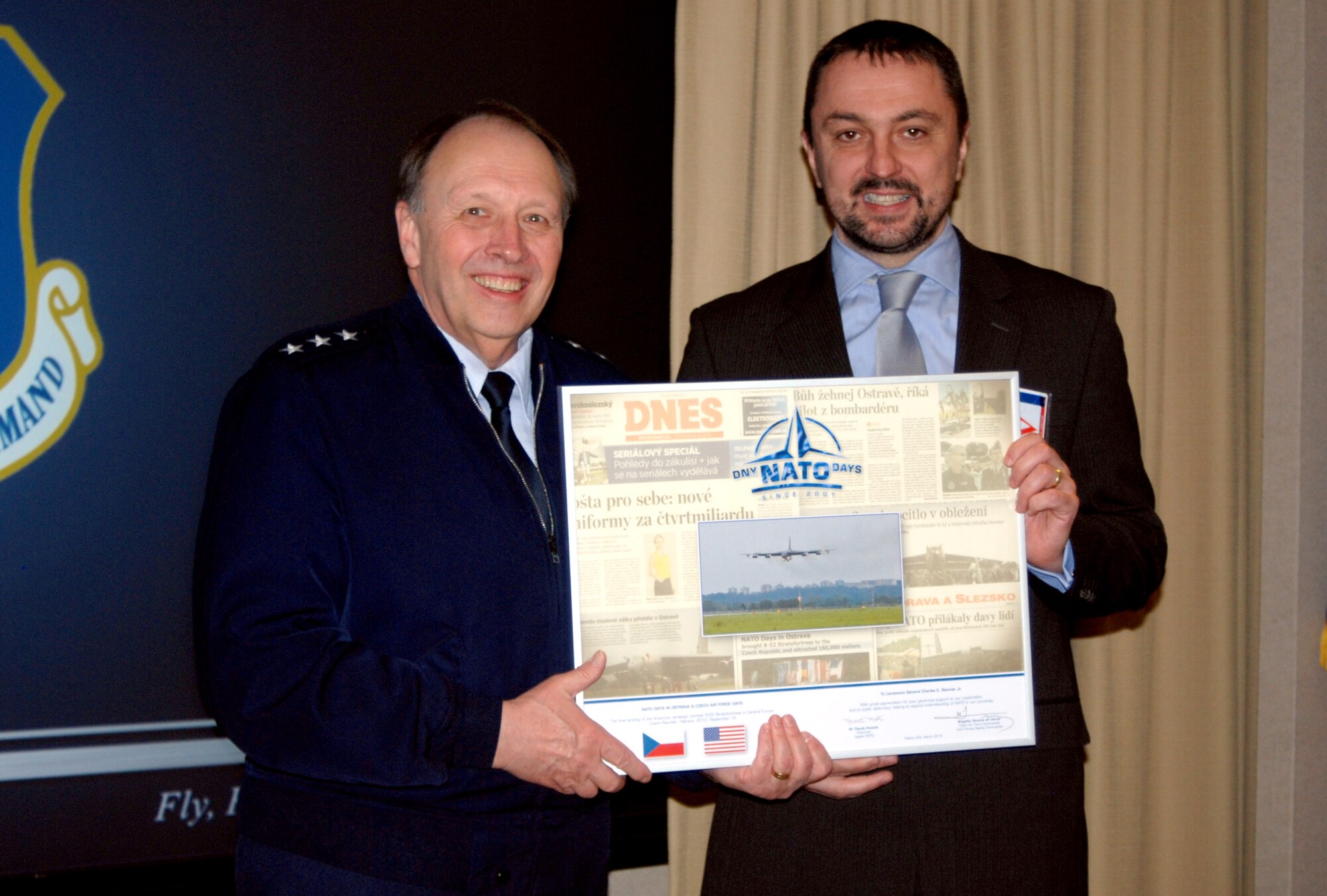 Lt. Gen. Charles E. Stenner, Jr., commander, Air Force Reserve Command, receives a commemorative collage from Zbynek Pavlacík, chairman of the Jagello 2000 Association, in the Headquarters AFRC Conference Room here, March. 8. The collage contained a newspaper article regarding AFRC’s 307th Bomber Wing participation in the “NATO Days in Ostrava” air show, along with a photo of the B-52 Bomber and a thank you note from Pavlacík and Brig. Gen. Jiri Verner, the deputy commander of the Joint Forces - Air Force Commander, Czech Republic.  Jagallo 2000 is a Czech Republic non-government organization specializing in the fields of defense and public diplomacies focusing primarily on raising awareness of and the promotion of international security issues in general public, specifically on the role of the North Atlantic Treaty Organization and the importance of the transatlantic bond between the U.S. and Europe. (U.S. Air Force photo/Peter Chadwick)
