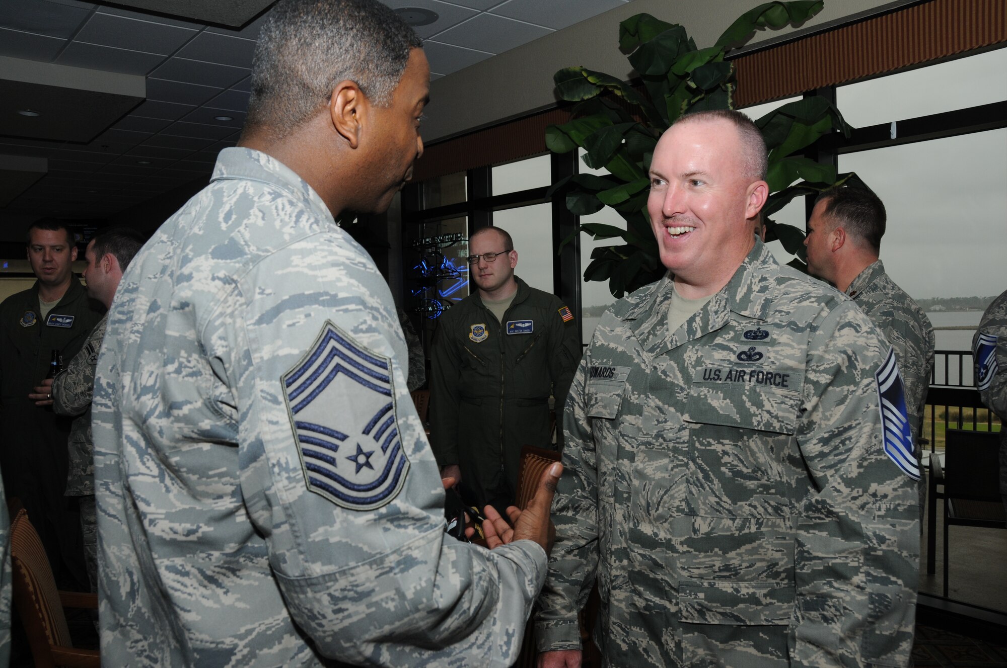 Chief Master Sgt. Michael Anderson, 81st Medical Group superintendant, congratulates Master Sgt. Craig Edwards, 81st Training Support Squadron, on his selection to the rank of Senior Master Sgt. during a promotion selection party at the Bay Breeze Event Center March 8, 2012, Keesler Air Force Base, Miss.  (U.S. Air Force photo by Kemberly Groue)