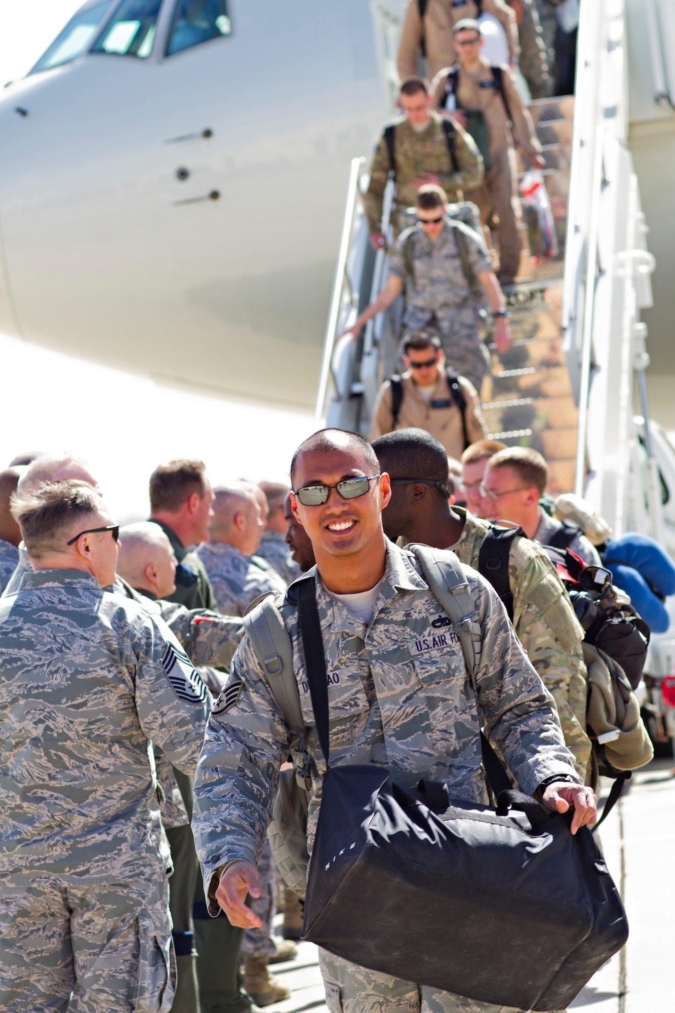 Airmen returning from deployment exit the aircraft and shake hands with 27th Special Operations Wing leadership during Operation Homecoming on the Cannon Air Force Base, N.M., flightline March 7. Operation Homecoming is a monthly event held to welcome Air Commandos back from worldwide deployments and reunite them with family and friends.  (U.S. Air Force photo by 1st Lt. Stephanie Schonberger)