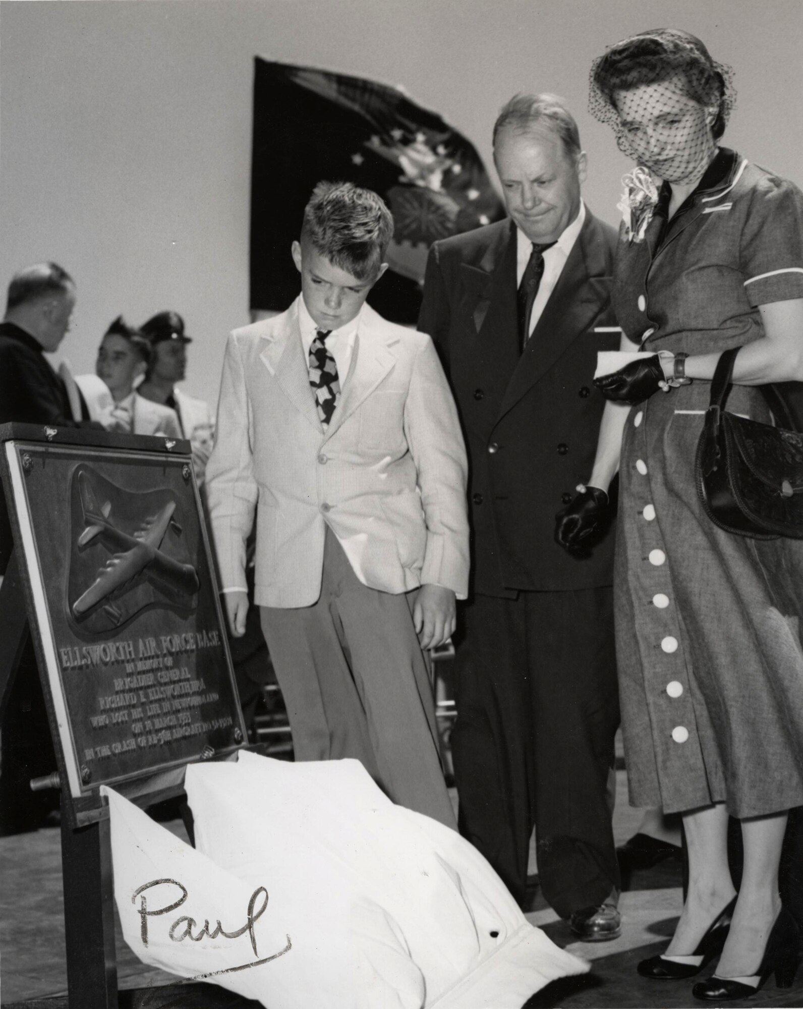 Mrs. Richard Ellsworth, Paul Ellsworth and Senator Karl E. Mundt inspect the plaque uncovered by President Dwight D. Eisenhower during a dedication ceremony renaming the base "Ellsworth Air Force Base," June 13, 1953. (Courtesy photo from South Dakota Air and Space Museum)