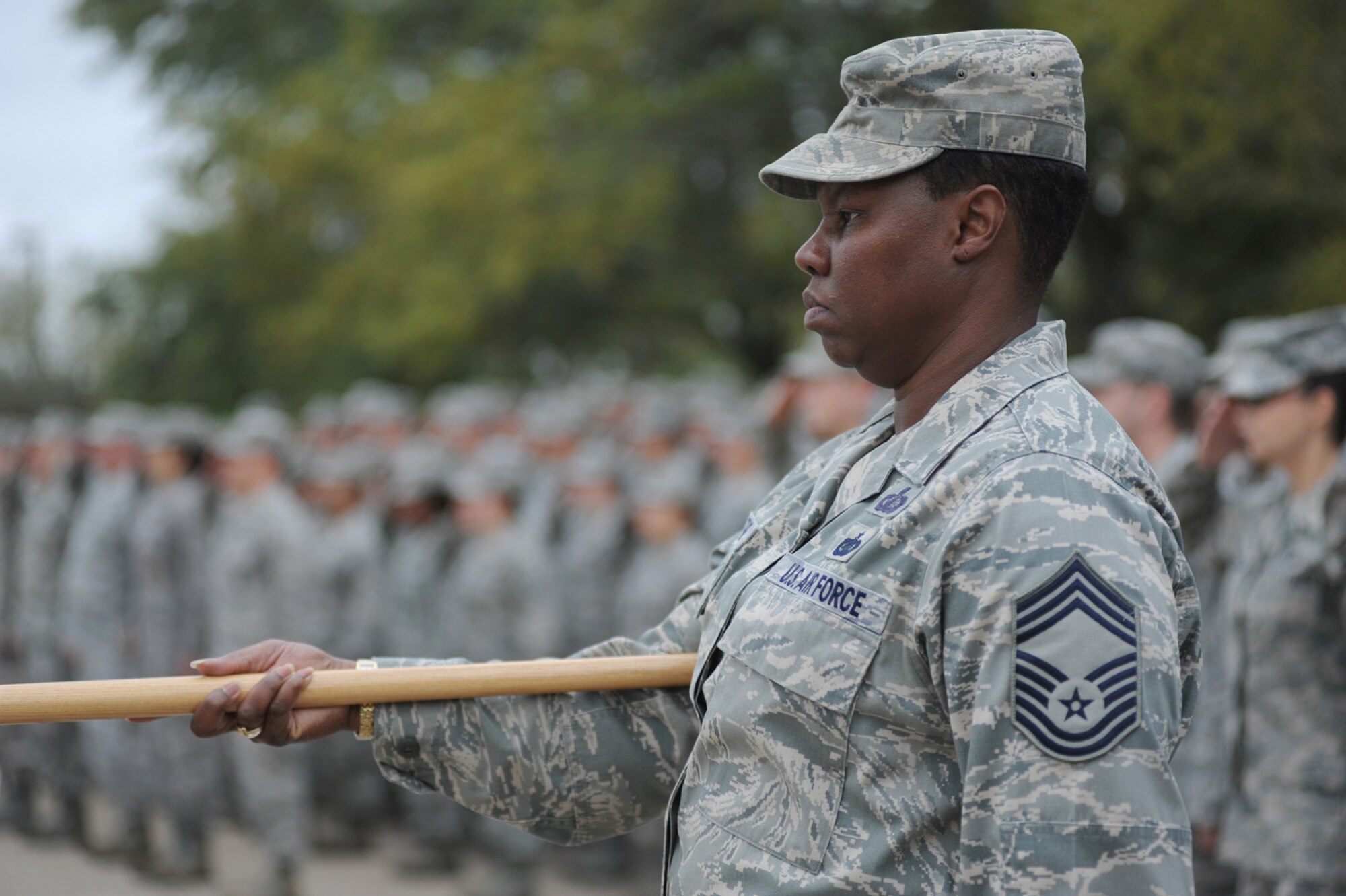 Chief Master Sgt. Lisa Boothe, 81st Mission Support Group superintendant, presents arms during the 81st Training Wing retreat ceremony March 9, 2012, Keesler Air Force Base, Miss.  Military Training Leaders serve as the flag security detail and performed a flag folding ceremony and the Drum and Bugle Corps played the Nation Anthem and America the Beautiful.  (U.S. Air Force photo by Kemberly Groue)