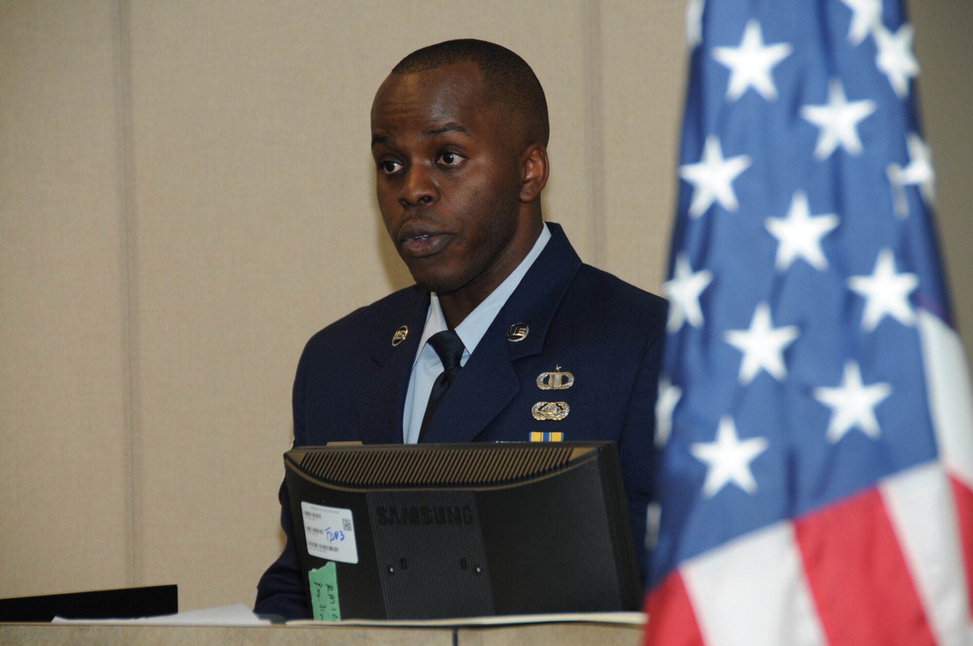 Tech. Sgt. Ronald Brown Jr., 334th Training Squadron instructor supervisor, is the master of ceremonies during his brother’s air traffic control apprentice course graduation ceremony, Airman 1st Class Christopher Brown, 334th TRS, graduated March 7, 2012, at Cody Hall, Keesler Air Force Base, Miss.  The Brown brothers’ father, retired U.S. Air Force major Ronald Brown from Arizona, also attended the ceremony.  (U.S. Air Force photo by Kemberly Groue)