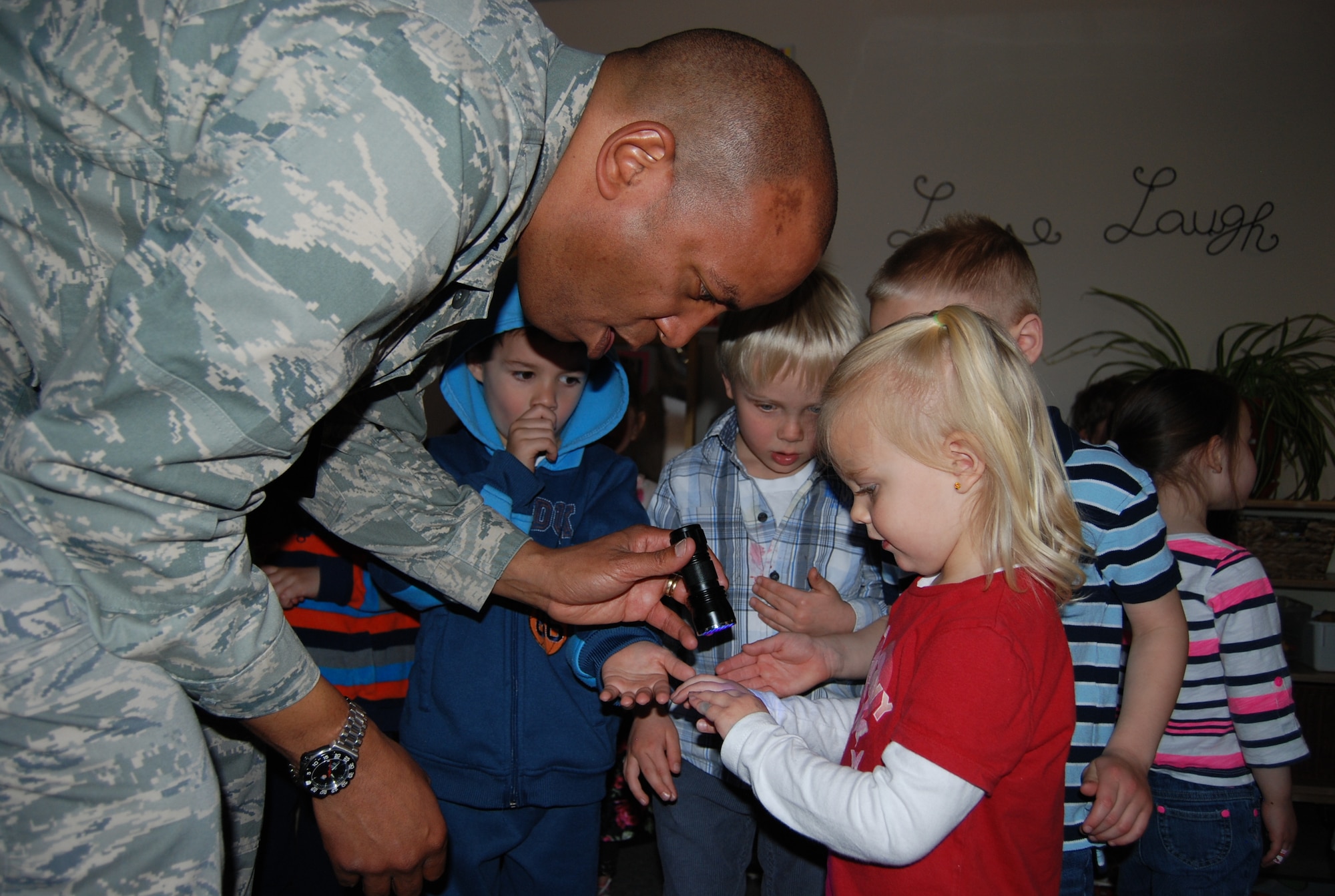 Lt. Col. Terence Mitchell, 21st Medical Group chief of medical staff, checks McKenzie Williams’ hands under a black light to see how well she washed her hands. The hand washing presentation at the Child Development Center was part of Patient Safety Week, March 4-10. This year’s theme was “Be Aware for Safe Care.” (U.S. Air Force photo/Lea Johnson)