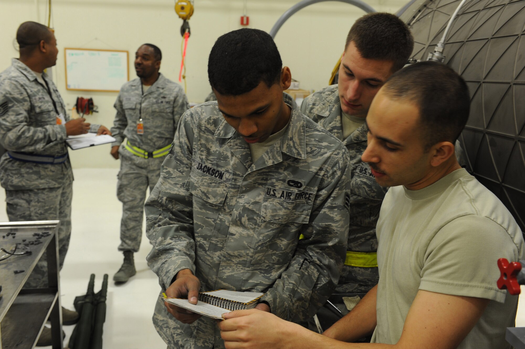 U.S. Air Force Senior Airmen Jerico Jackson and Cody Hammond along with Airman 1st Class Justin Stringer, aerospace propulsion journeymen from the 18th Component Maintenance Squadron reflect back to their Airmen’s Manual during local operational readiness exercise Beverly High 12-3 on Kadena Air Base, Japan, March 13, 2012. LOREs give Airmen the opportunity to practice readiness skills and prepare for real world contingencies. (U.S. Air Force photo by Airman 1st Class Justin Veazie/released)