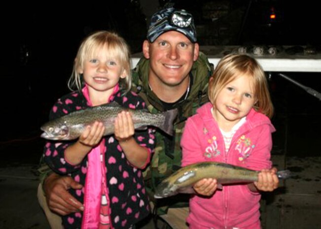 Master Sgt. Chad Hepner, 9th Medical Group first sergeant, displays the days catch with his daughters after a family fishing trip. Although Hepner is a devoted hunter, he said he enjoys fishing during off seasons. (U.S. Air Force courtesy photo)