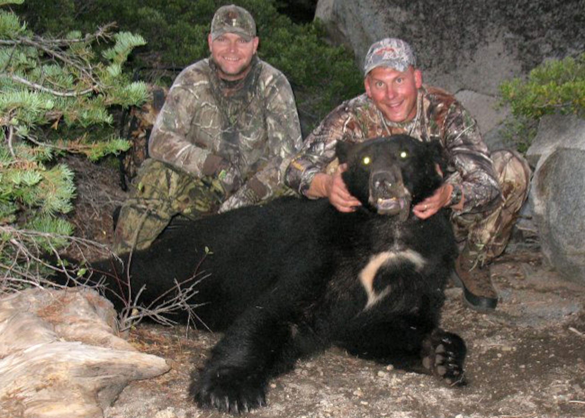 (Right) Master Sgt. Chad Hepner, 9th Medical Group first sergeant, and (left) Master Sgt. Nathan Schmidt, 9th Security Forces Squadron first sergeant, pose with a black bear Hepner harvested in California during the 2011 bear season. Hepner hunts so much that his family hasn't bought a cut of meat from a grocery store in 19 years. (U.S. Air Force courtesy photo)