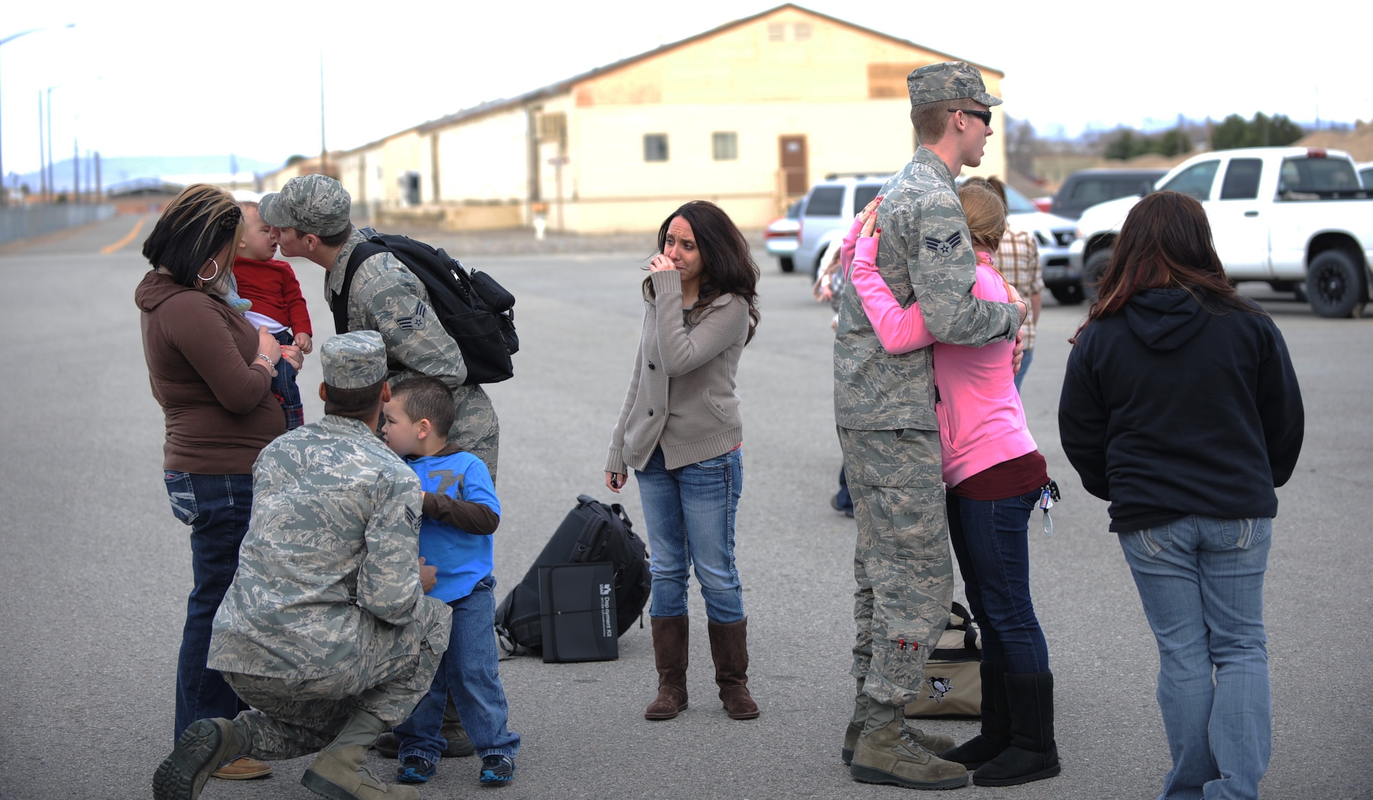 Airmen say goodbye to their families before deploying, March 12, 2012, at Mountain Home Air Force Base, Idaho. The group is part of the more than 300 Airmen who are deploying from the base to support the flying operations of the 391st Fighter Squadron "Bold Tigers." (U.S. Air Force photo/ Airman 1st class Jonathan Glanville/Released)