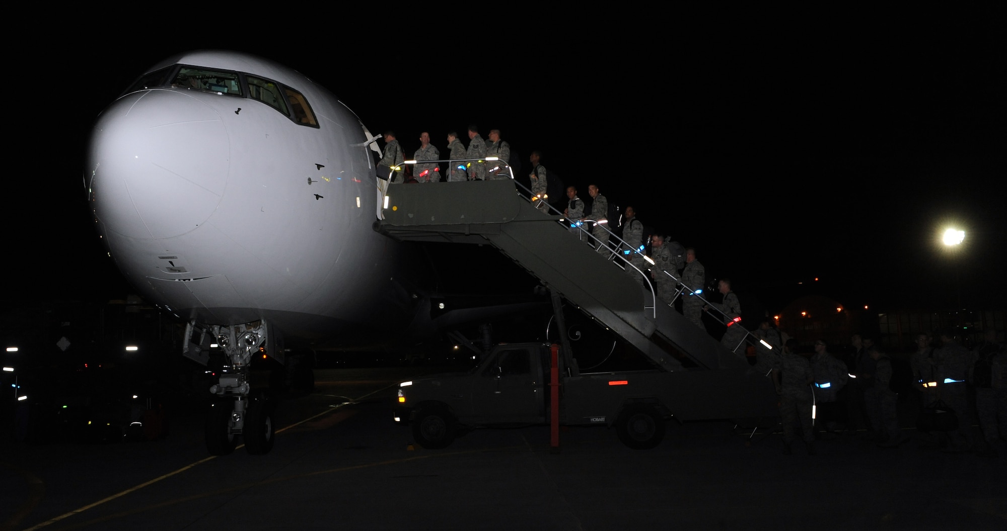 Airmen from the 366th Fighter Wing board a Boeing 767 while leaving for a deployment March 12, 2012, at Mountain Home Air Force Base, Idaho. Airmen in a variety of non-aviation roles will be conducting a wide range of tasks to ensure the success of providing critical combat power capabilities in that region of the world. (U.S. Air Force photo/Senior Airman Debbie Lockhart)