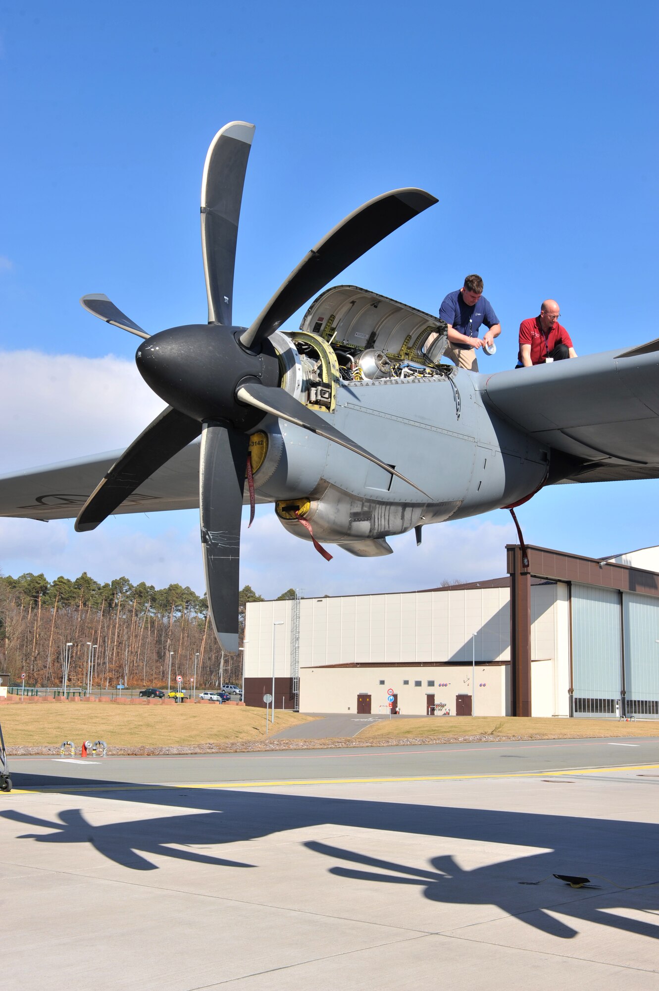 George Evans, Rolls-Royce mechanic, and Ben Choates, Air Force Engineering Technical Services mechanic, perform maintenance and run a series of tests on the engine of a C-130J Super Hercules, Ramstein Air Base, Germany, March 12, 2012. The Rolls-Royce Company builds aircraft engines as well as provides support for maintenance. (U.S. Air Force photo/ Airman 1st Class Caitlin O'Neil-McKeown)