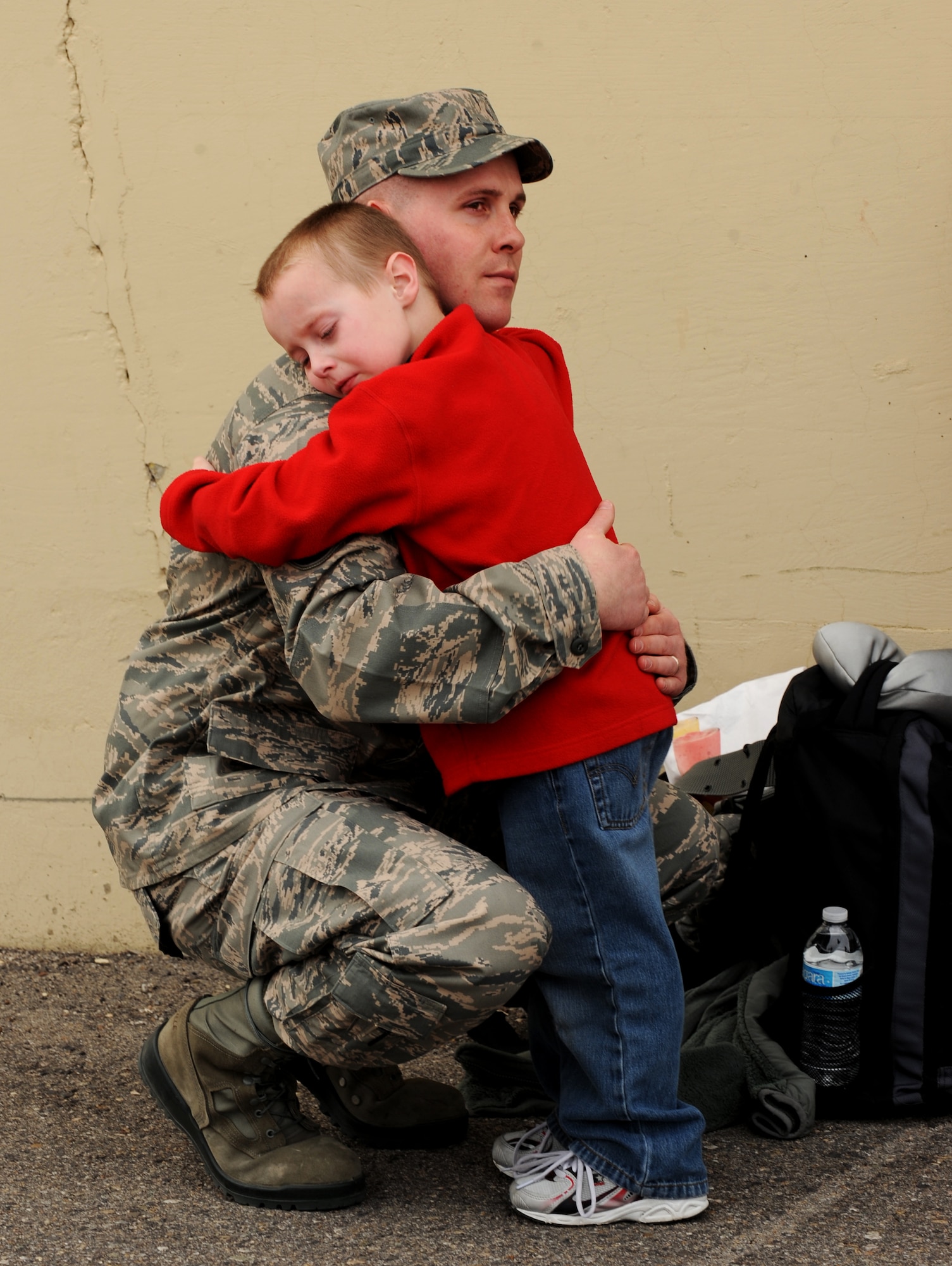 U.S. Air Force Staff Sgt. Brian Vetter, 366th Maintenance Operations Squadron, hugs his son Keegan goodbye before leaving for deployment March 12, 2012, at Mountain Home Air Force Base, Idaho. The Mountain Home Airmen will support F-15E overseas contingency missions designed to deliver combat air power for joint operations to meet combatant commander requirements. (U.S. Air Force photo/Senior Airman Debbie Lockhart)