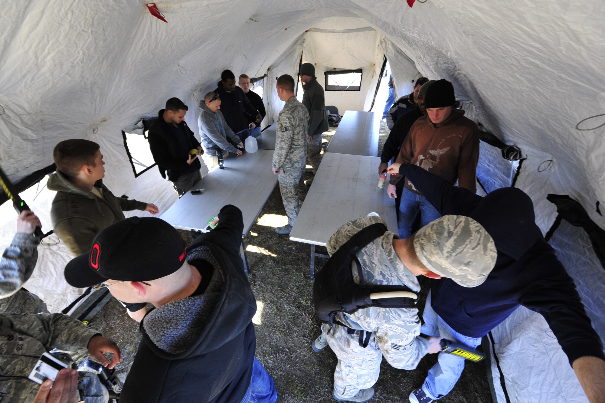 JOINT BASE MCGUIRE-DIX-LAKEHURST, N.J. – Airmen from the 621st Contingency Response Wing acting as role players are searched for weapons during a simulated emergency evacuation of American citizens ahead of a volcanic eruption here March 7. This noncombatant evacuation operation is a mission the CRW has never been called upon to perform, and honing these skills adds a new capability to the Contingency Response Wing’s toolset. (U.S. Air Force photo by Tech. Sgt. Parker Gyokeres) (Released)