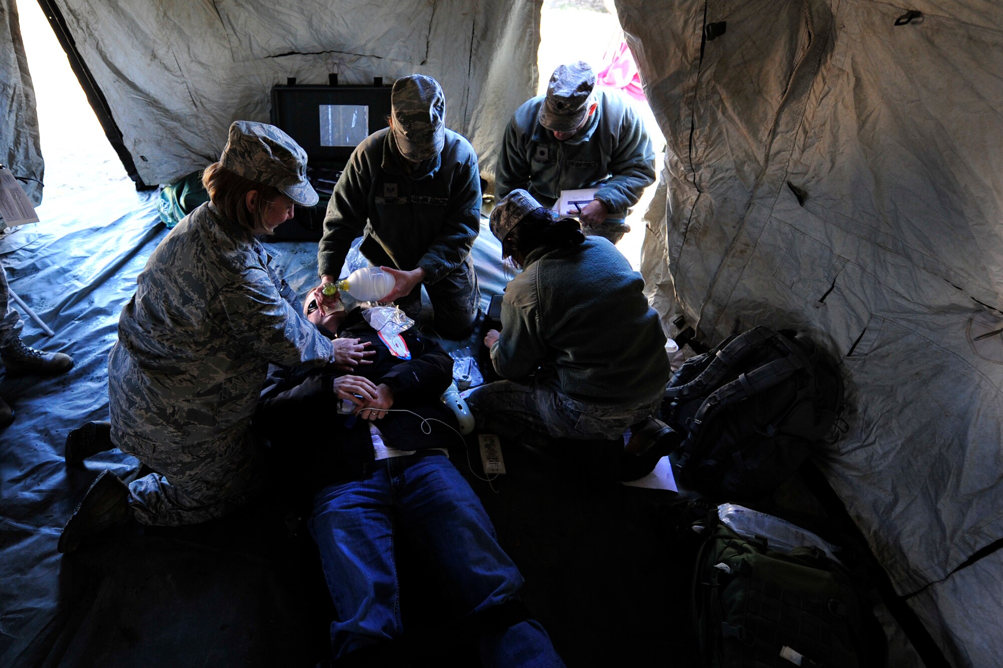 JOINT BASE MCGUIRE-DIX-LAKEHURST, N.J. –Airmen from the 87th Medical Group place an automated external defibrillator on a role player during a simulated medical emergency here March 7. Mobility Airmen from the 817th Contingency Response Group, 87th MDG and Detachment 307 of the Air Force Office of Special Investigations worked together to simulate the emergency evacuation of American citizens ahead of a volcanic eruption. The NEO, or noncombatant evacuation operation, is a mission the CRW has never performed, and adds a new capability to the Contingency Response Wing’s toolset. (U.S. Air Force photo by Tech. Sgt. Parker Gyokeres) (Released)