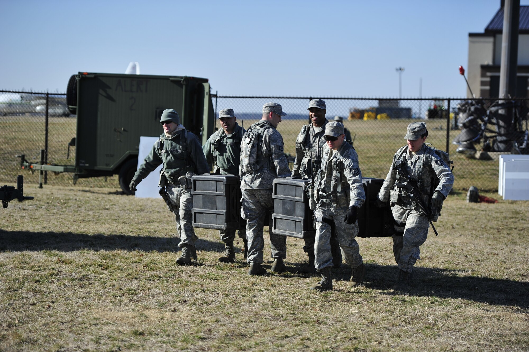 JOINT BASE MCGUIRE-DIX-LAKEHURST, N.J. – Security forces Airmen from the 817th Contingency Response Group work together to move equipment for camp set up during the emergency evacuation of U.S. citizens ahead of a simulated volcanic eruption here March 7. This noncombatant evacuation operation is a mission the CRW has never performed, and honing these skills adds a new capability to the unit's toolset. (U.S. Air Force photo by Tech. Sgt. Parker Gyokeres) (Released)