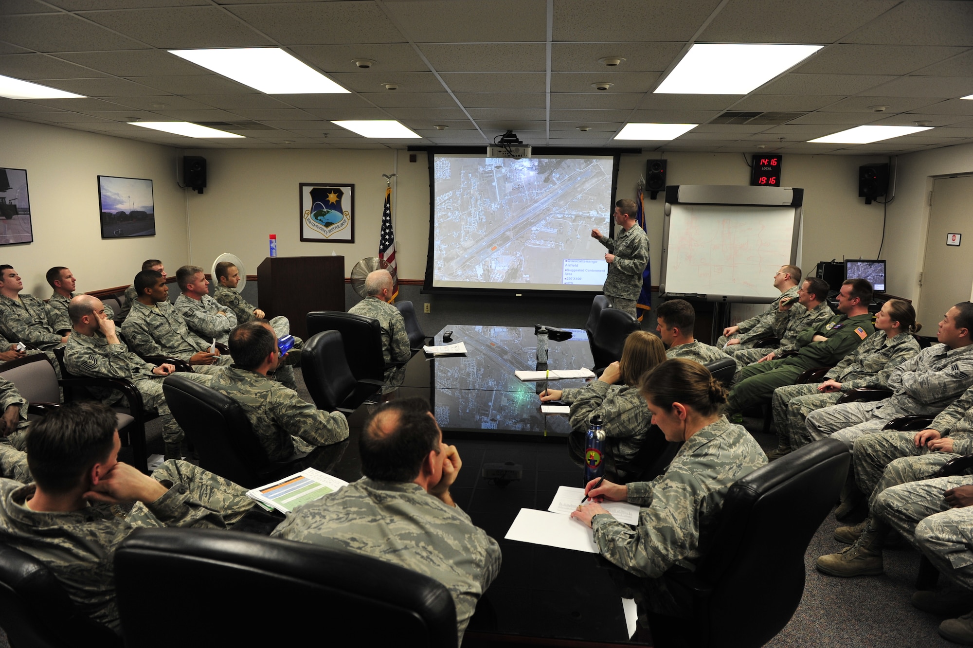 JOINT BASE MCGUIRE-DIX-LAKEHURST, N.J. – Mobility Airmen from the 817th Contingency Response Group, 87th Medical Group and Detachment 307 of the Air Force Office of Special Investigations perform mission planning during the simulated emergency evacuation of American citizens ahead of a volcanic eruption here March 6. This noncombatant evacuation operation is a mission the CRW has never performed, and honing these skills adds a new capability to the unit's toolset. (U.S. Air Force photo by Tech. Sgt. Parker Gyokeres) (Released)