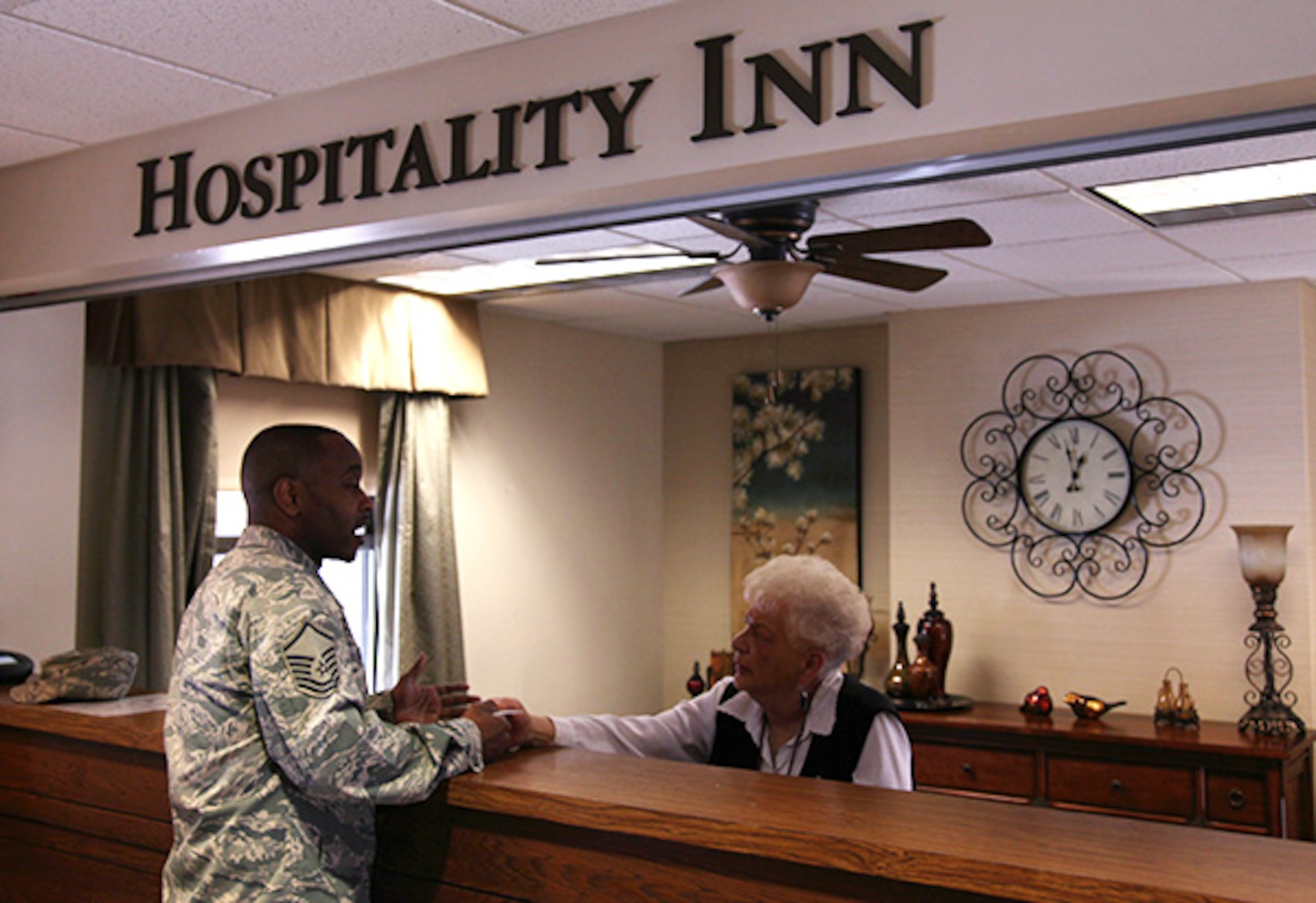 Master Sgt. Lafayette Smith Jr., assigned to the 910th Airlift Wing from Youngstown Ohio, receives his key access card from the front desk clerk at the Pittsburgh lodging building, Feb. 28, 2012. The Hospitality Inn continuously houses all military members and their families, DoD civilians and contractors. (U.S. Air Force photo by Tech. Sgt. Ralph Van Houtem/Released)