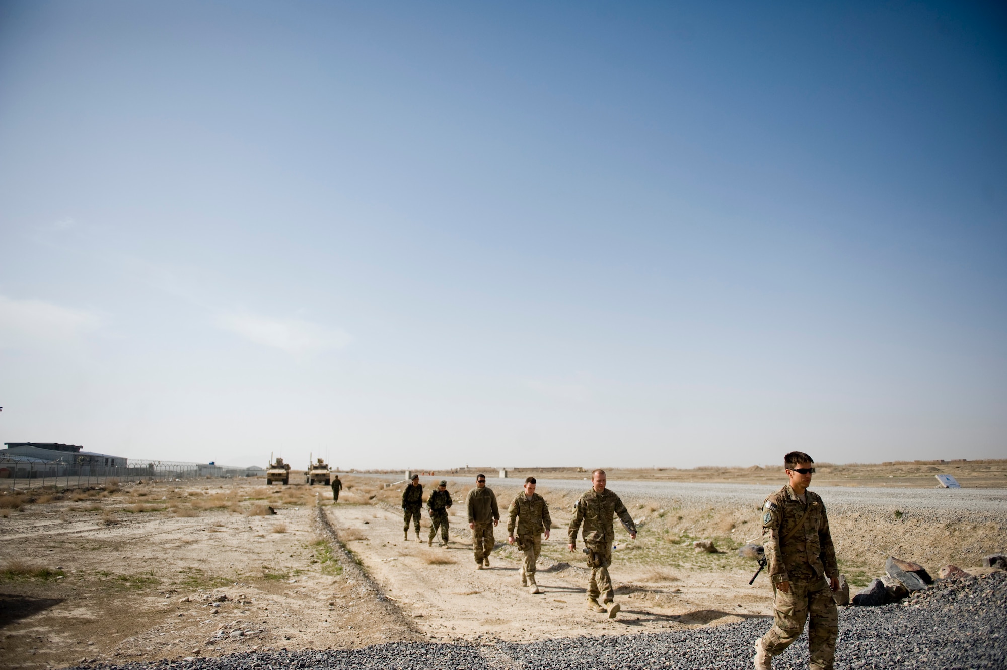 KANDAHAR, Afghanistan -- Staff Sgt. Kenneth Guinn (far right), 966th Explosive Ordnance Disposal Flight Operating Location-Bravo partnership team member, leads the team to a training area for practice operations March 13, 2012. Airmen assigned to the partnership team within OL-B train, mentor and subsequently validate Afghan National Army EOD technicians. (U.S. Air Force photo by Staff Sgt. Greg C. Biondo)  