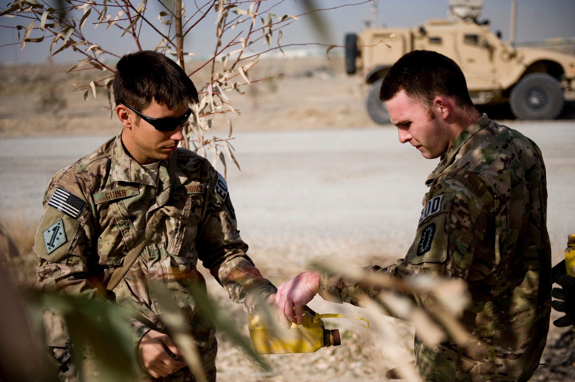 KANDAHAR, Afghanistan – Staff Sgt. Kenneth Guinn (left) and Senior Airman Lee Mclean, 966th Explosive Ordnance Disposal Flight Operating Location-Bravo partnership team, prepare an inert improvised explosive device for practice operations March 13. Airmen assigned to the partnership team within OL-B train, mentor and subsequently validate Afghan National Army EOD technicians. (U.S. Air Force photo by Staff Sgt. Greg C. Biondo)