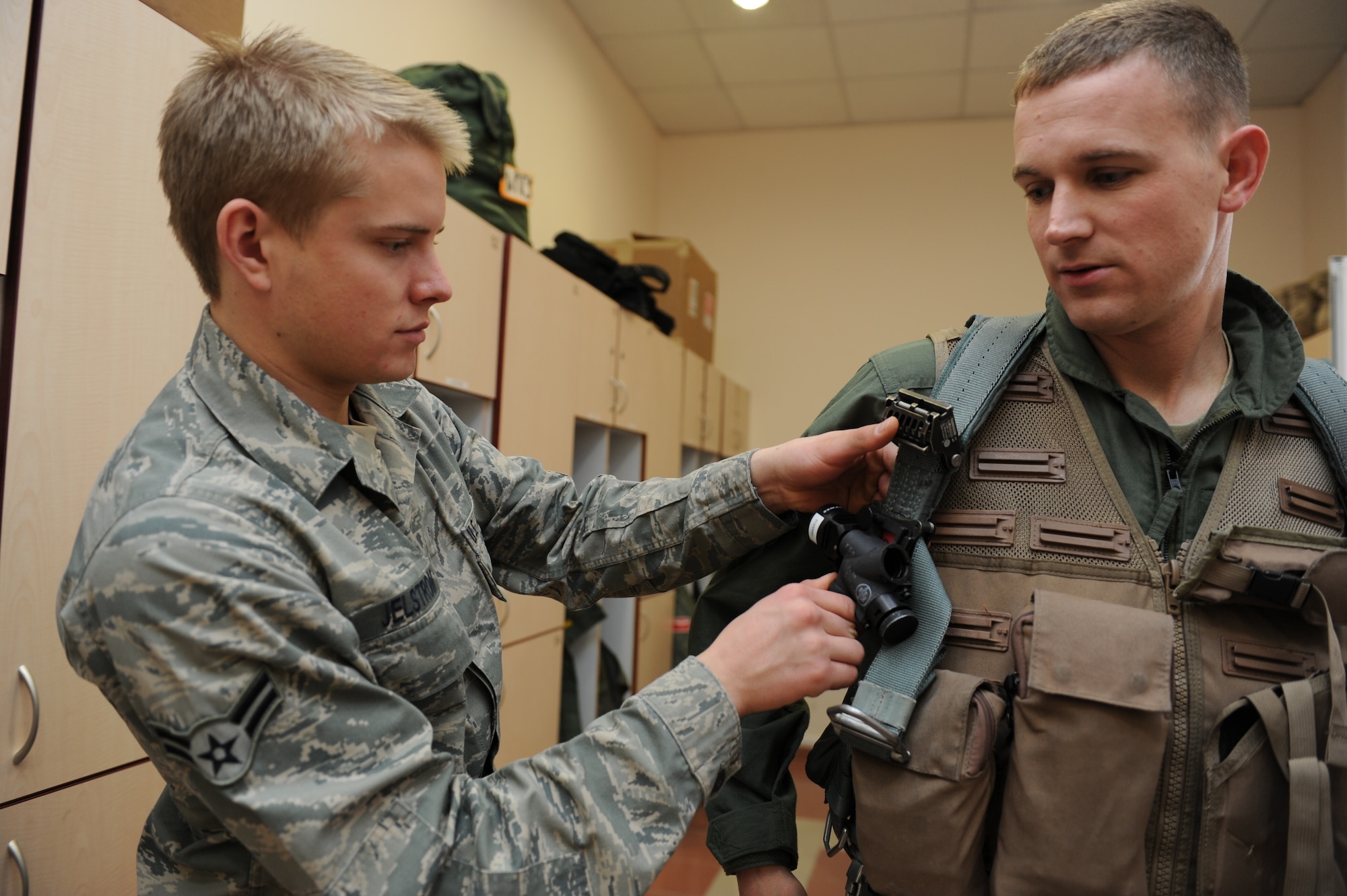 KONYA, Turkey -- Airman 1st Class Ryan Jelstrom, aircrew flight equipment, fits Staff Sgt. Jasen Hasland, avionics technician, with life support equipment before his orientation flight during Exercise Anatolian Falcon 2012, March 12. During the bilateral training exercise the 480th Fighter Squadron flew missions with the Turkish air force to practice air interdiction, attack, air superiority, defense suppression, airlift, air refueling and reconnaissance. (U.S. Air Force photo/Staff Sgt. Benjamin Wilson)