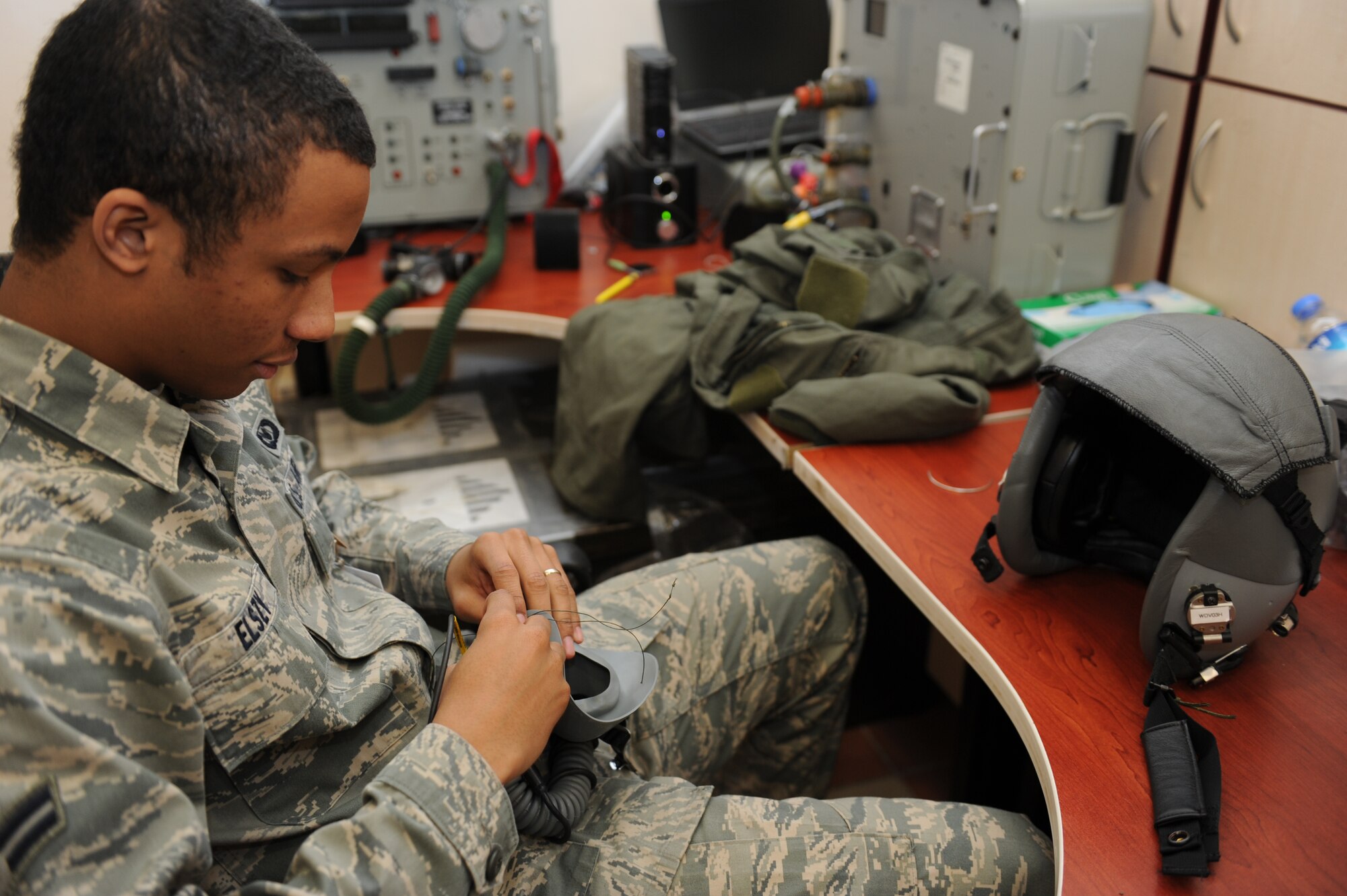 KONYA, Turkey -- Airman 1st Class Adryan Elszy, aircrew flight equipment, tacks the adjustment straps of a mask down to ensure the stay in position and the mask maintains a good seal during flight, March 12. Elszy was participating in Exercise Anatolian Falcon 2012, bilateral training exercise with the U.S. and Turkish air forces. (U.S. Air Force photo/Staff Sgt. Benjamin Wilson)