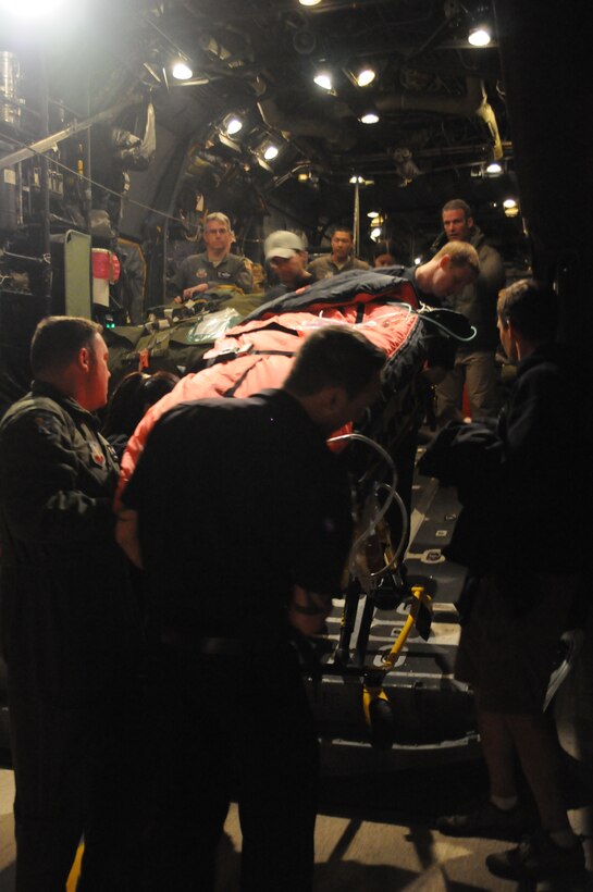 129th Rescue Wing Airmen and San Diego area first responders transfer an injured fisherman to San Diego area paramedics at Marine Corps Air Station Miramar, Calif., March 12, 2012. 129th RQW Airmen conducted a long-range over-water rescue mission 700 miles off the coast of Mexico March 10-12 to save two fishermen who were burned in a diesel fire onboard the Chinese fishing vessel, Fu Yuan Yu #871. (Air National Guard Photo by Master Sgt. Julie Avey)