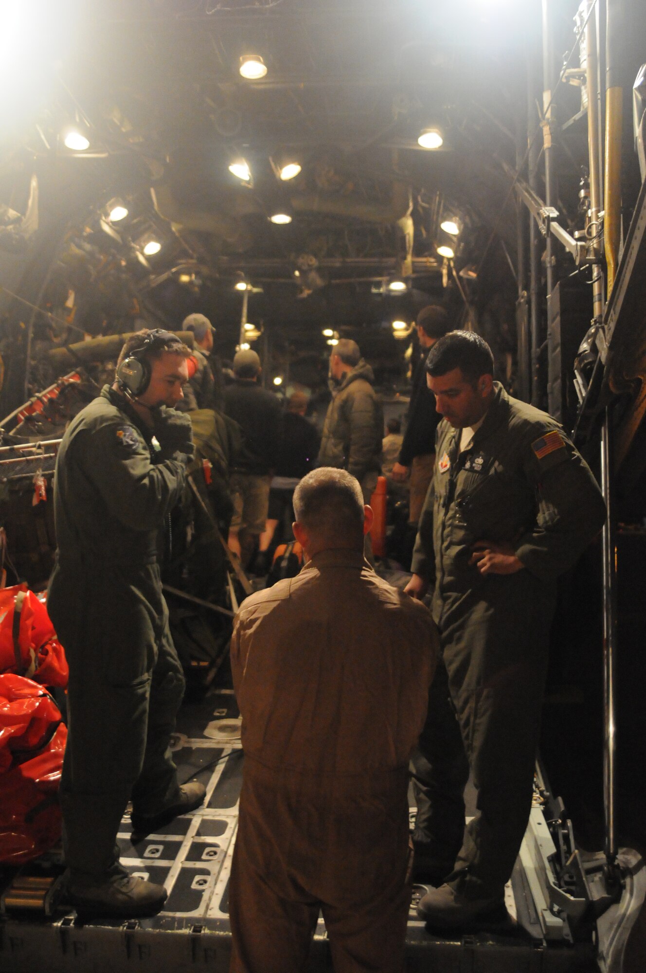 129th Rescue Wing Airmen prepare to transfer injured fishermen onboard an MC-130P Combat Shadow aircraft to an awaiting ambulance at Marine Corps Air Station Miramar near San Diego, Calif., March 12, 2012. 129th RQW Airmen conducted a long-range over-water rescue mission 700 miles off the coast of Mexico March 10-12 to save two fishermen who were burned in a diesel fire onboard the Chinese fishing vessel, Fu Yuan Yu #871. (Air National Guard Photo by Master Sgt. Julie Avey)