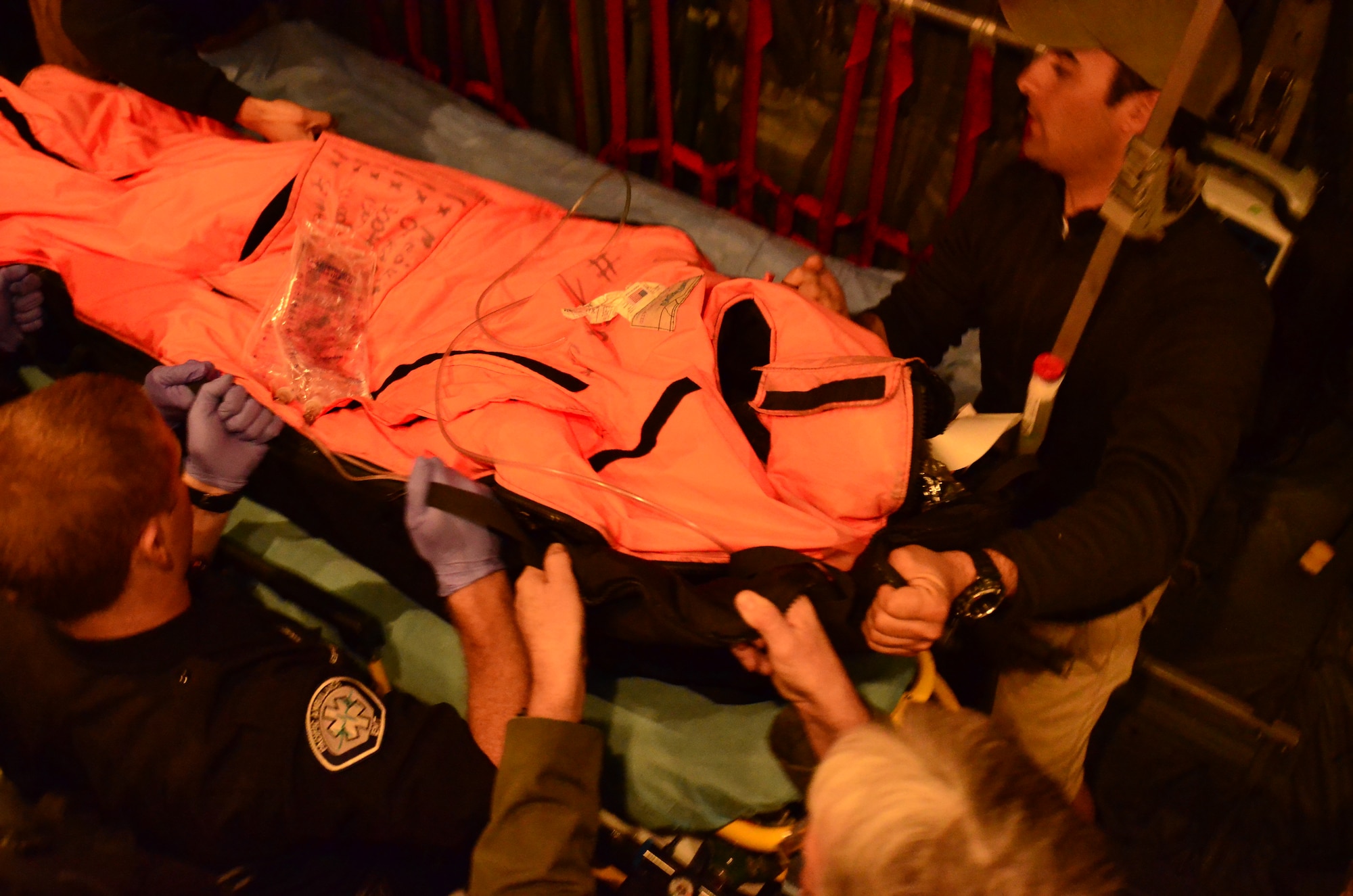 129th Rescue Wing Airmen and San Diego area first responders prepare to transfer an injured fisherman onboard an MC-130P Combat Shadow aircraft to an awaiting ambulance at Marine Corps Air Station Miramar near San Diego, Calif., March 12, 2012. 129th RQW Airmen conducted a long-range over-water rescue mission 700 miles off the coast of Mexico March 10-12 to save two fishermen who were burned in a diesel fire onboard the Chinese fishing vessel, Fu Yuan Yu #871. (Air National Guard photo by Airman 1st Class John Pharr)