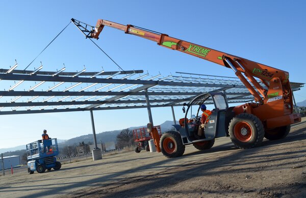 Construction workers build the frame for a one-megawatt solar microgrid project at Fort Hunter Liggett, Calif., Dec. 22, 2011. The frame will support photovoltaic panels, said Bob Roy, a project manager with the U.S. Army Corps of Engineers Sacramento District, which is overseeing the project. The grid, scheduled for completion in April 2012, is expected to be the first of four at the post. Once complete, the grid will generate enough energy to power 250 to 300 homes. Along with the energy production, the panel arrays will form a canopy that will shade the majority of the post’s vehicles. (U.S. Army photo by Carlos J. Lazo/Released)