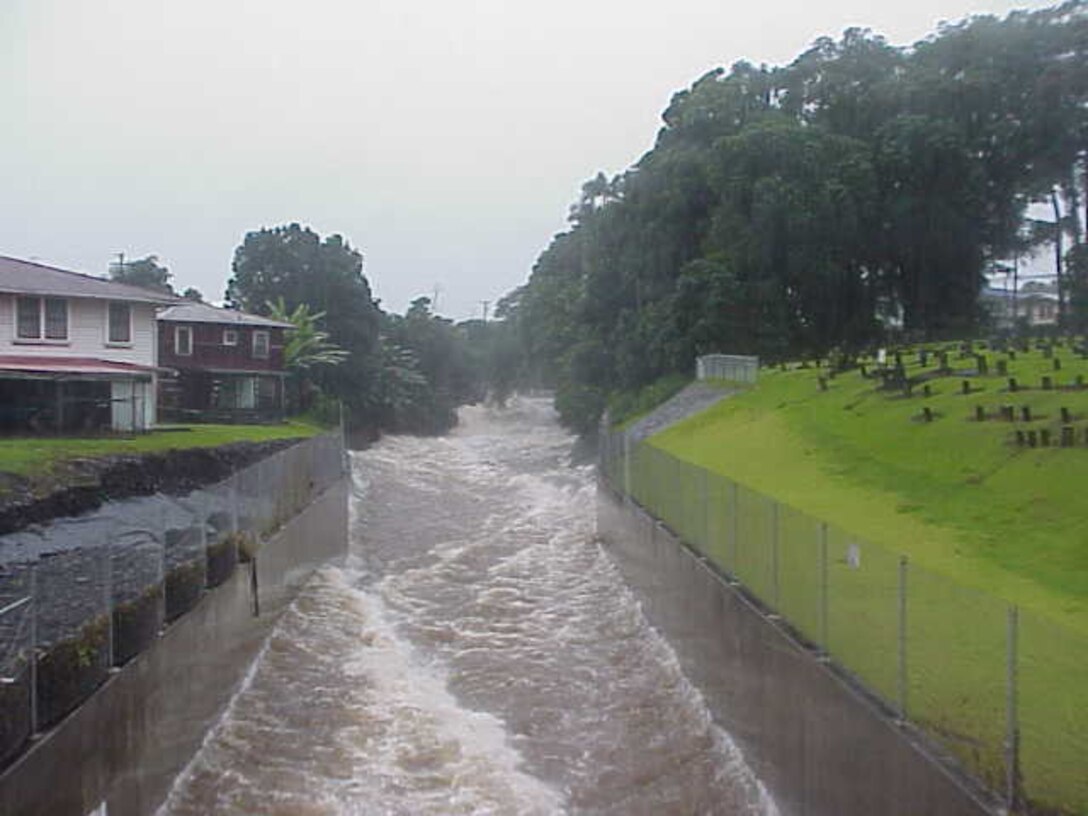 Photograph of the Corps-built flood control project on Alenaio stream, island of Hawaii. This picture depicts the project during the November 2000 flood event.