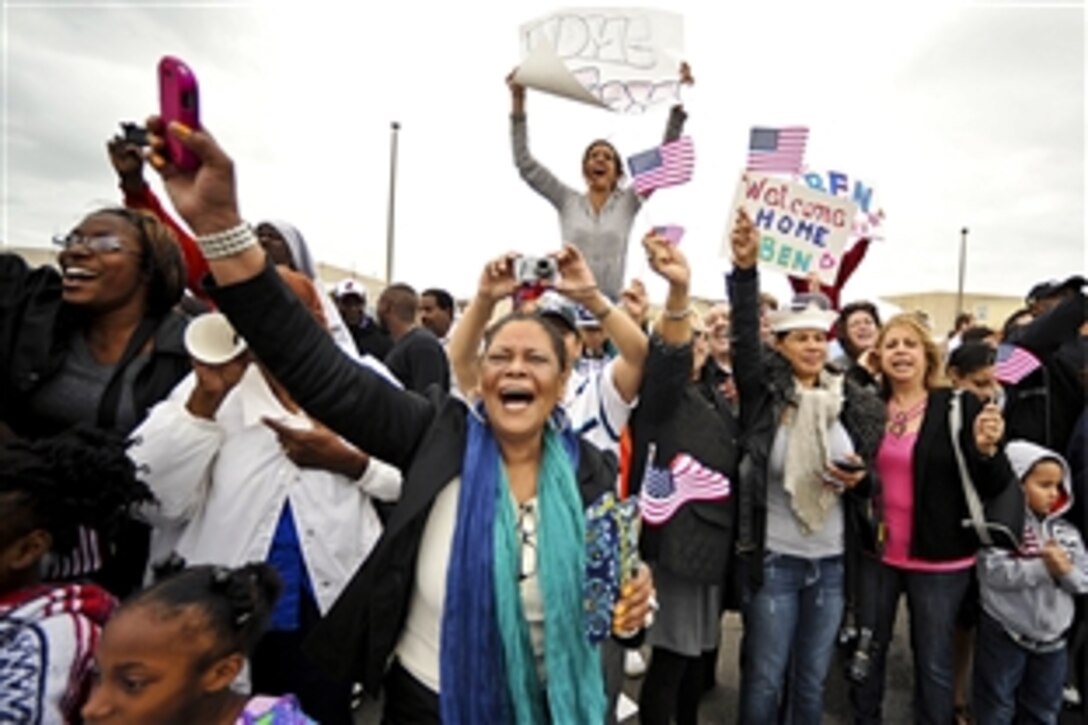 Friends and family members celebrate as the guided-missile frigate USS De Wert returns to homeport during a celebration on Naval Station Mayport in Mayport, Fla., March 10, 2012. The De Wert returned home after completing a seven-month counterpiracy deployment to the Horn of Africa and Indian Ocean.