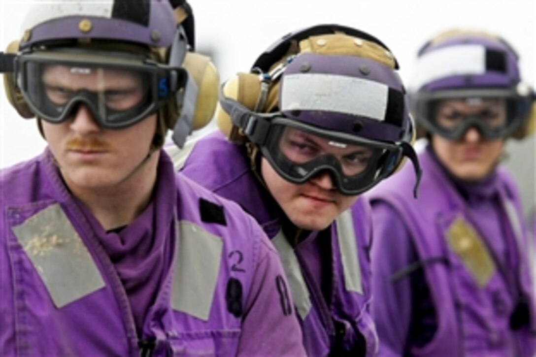 U.S. Navy sailors participate in a helicopter firefighting drill aboard the U.S. 7th Fleet flagship USS Blue Ridge in the Philippine Sea, March 13, 2012.