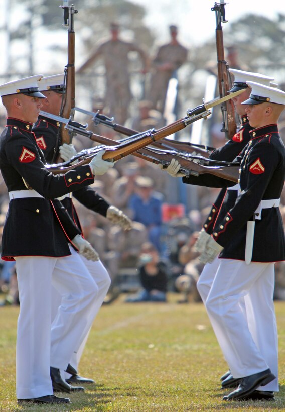 Master Gunnery Sgt. Kevin Buckles, the U.S. Marine Drum & Bugle Corps drum major, faces a packed crowd during a Battlefield Color Detachment ceremony aboard Marine Corps Base Camp Lejeune, N.C., March 14. Ending their National Installations Tour, the BCD featuring the U.S. Marine Drum & Bugle Corps, the U.S. Marine Corps Silent Drill Platoon and the Official Color Guard of the Marine Corps made their final appearance at Camp Lejeune.
